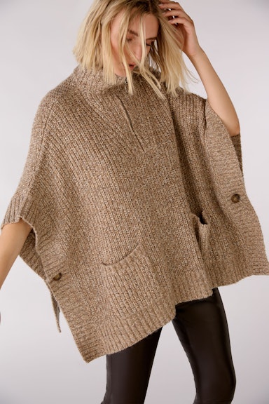 Knitted poncho with patch pockets and stand-up collar