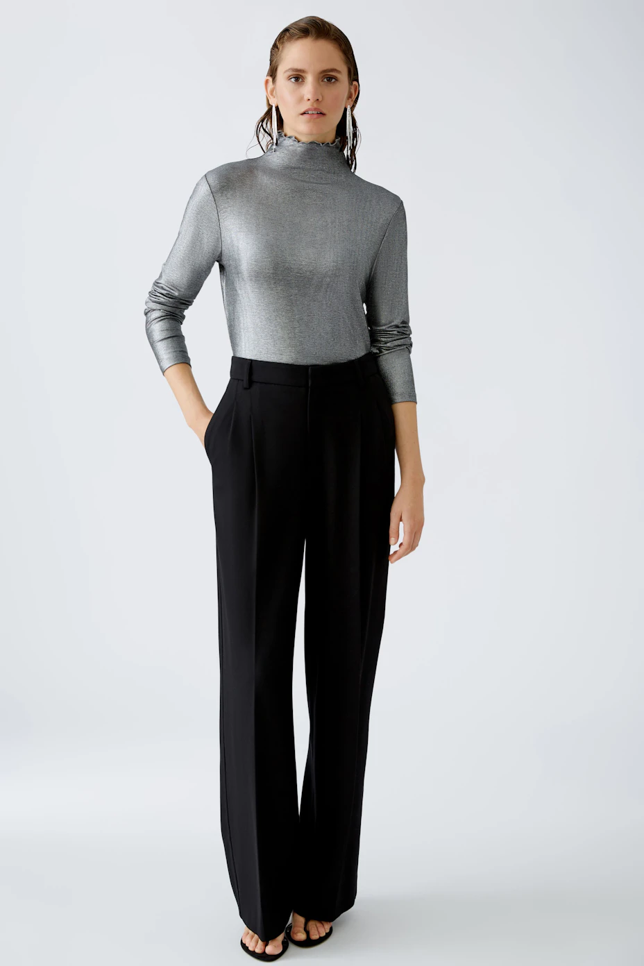 Stylish women's long-sleeve shirt in shimmering gray, perfect for layering or standalone wear.