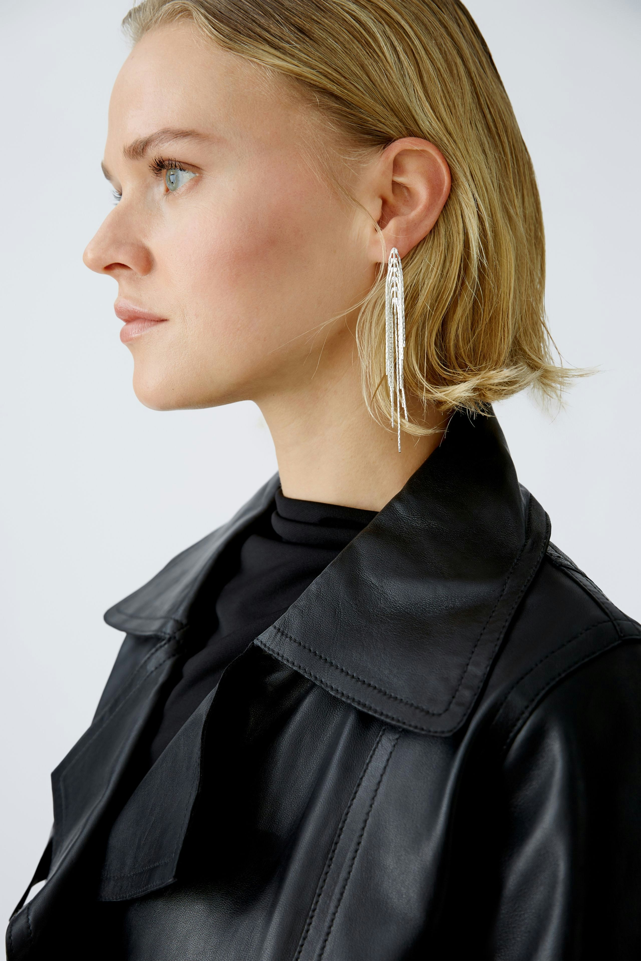 Stylish biker jacket: Woman in a sleek black leather biker jacket exudes confidence and modern elegance.