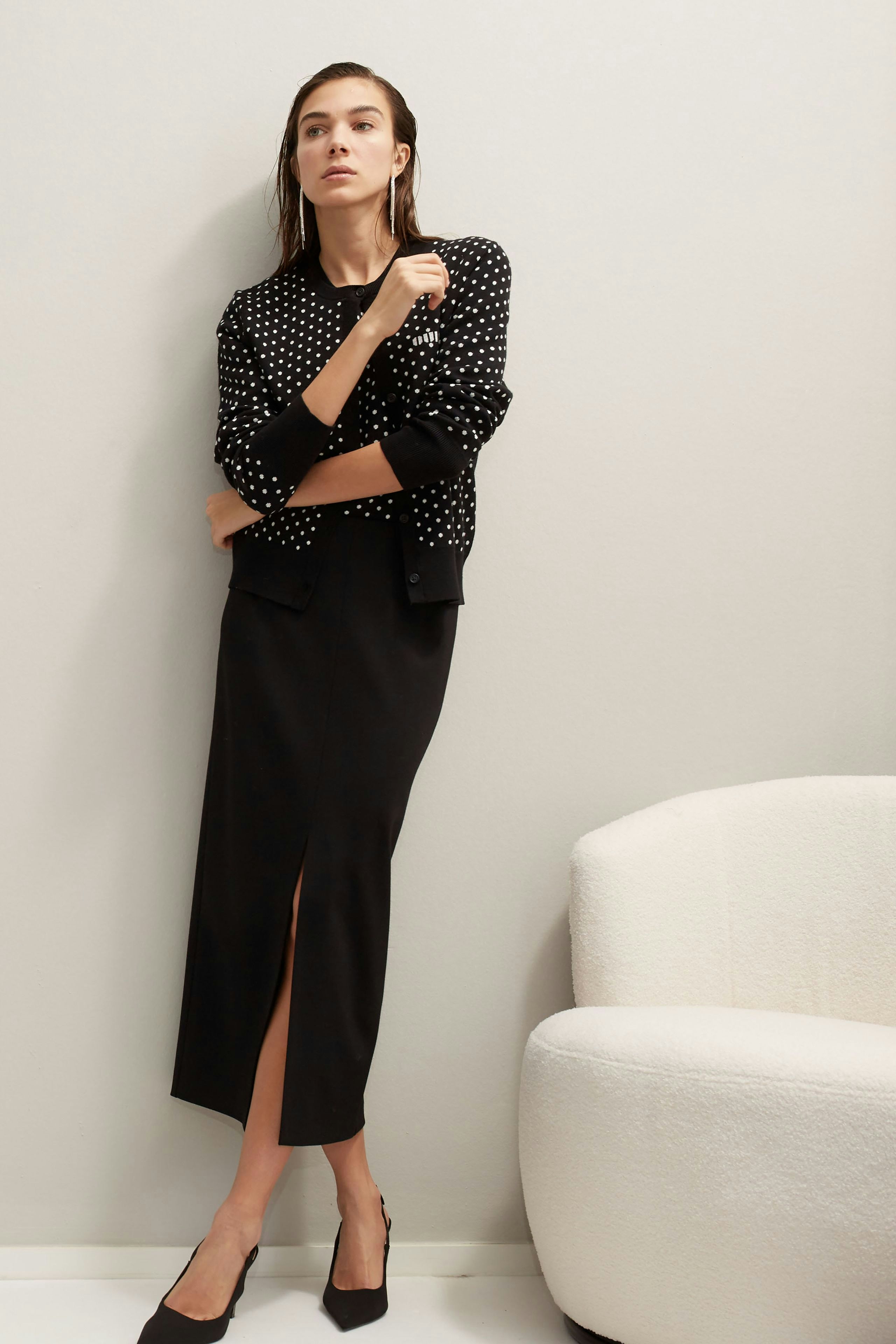 Elegant pencil skirt: A woman in a sleek black pencil skirt with a stylish slit, exuding confidence.