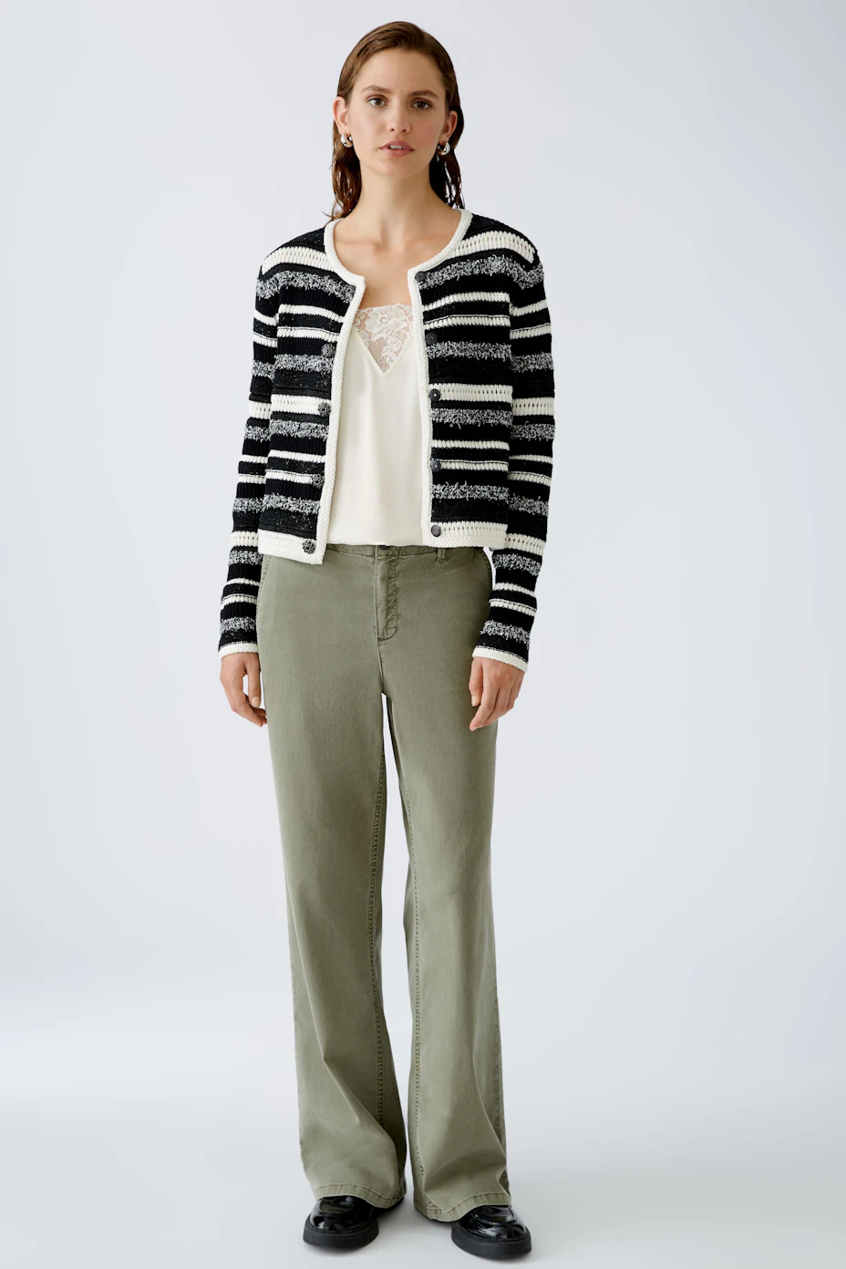 Stylish women's cardigan: A black and white striped pullover with a cropped fit, perfect for layering.