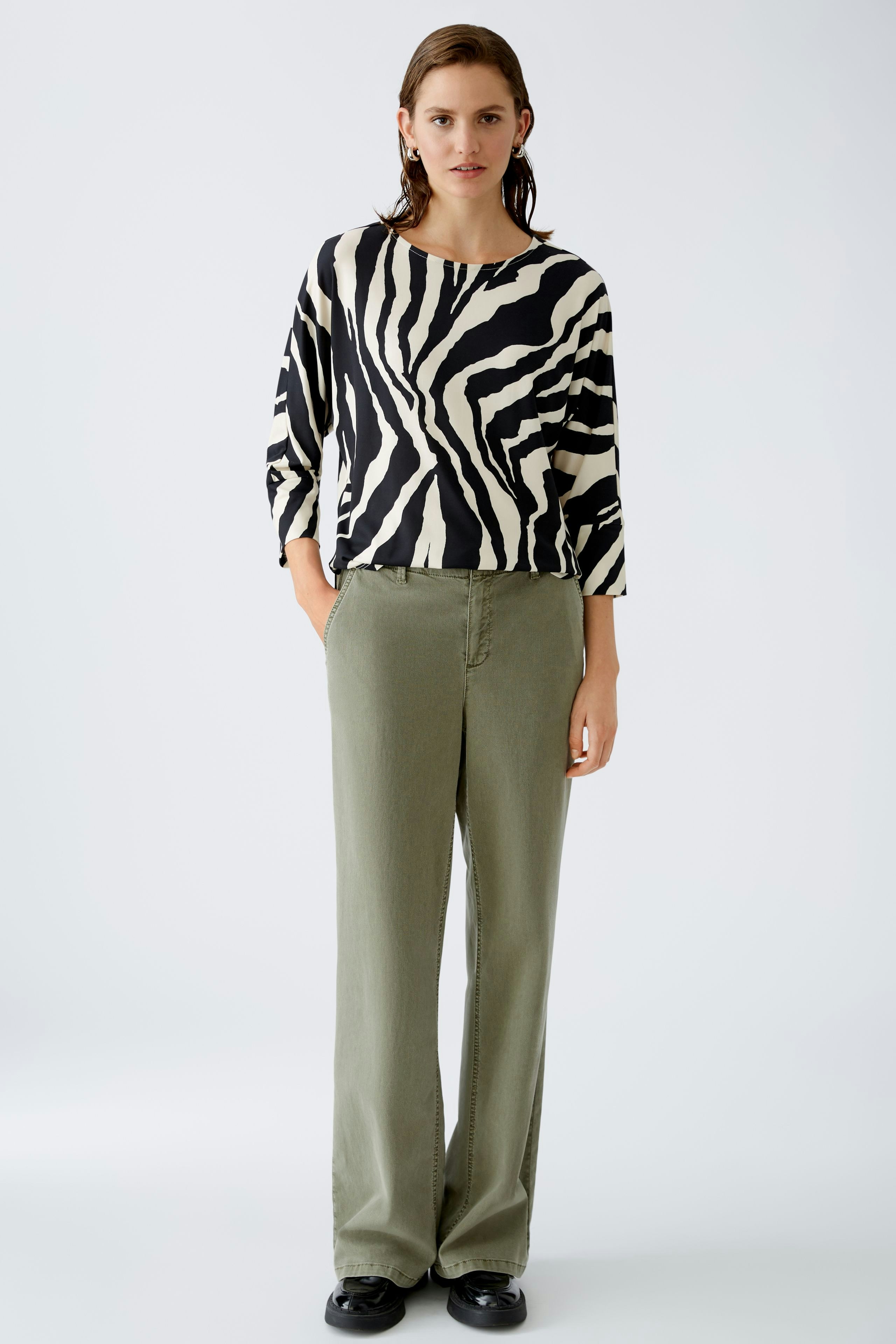 Stylish women's T-shirt with a bold zebra print, perfect for a trendy casual look.