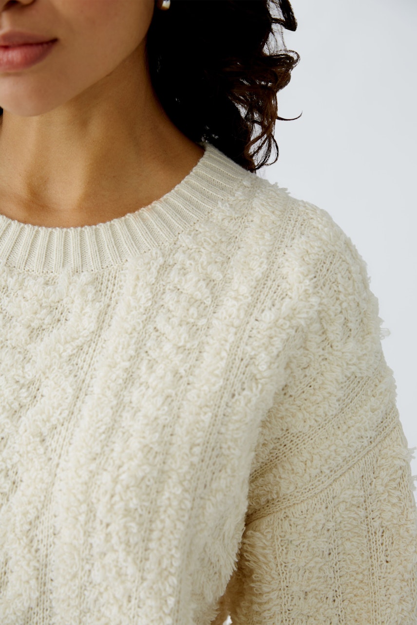 Cozy women's pullover in soft cream with textured knit, perfect for casual styling.