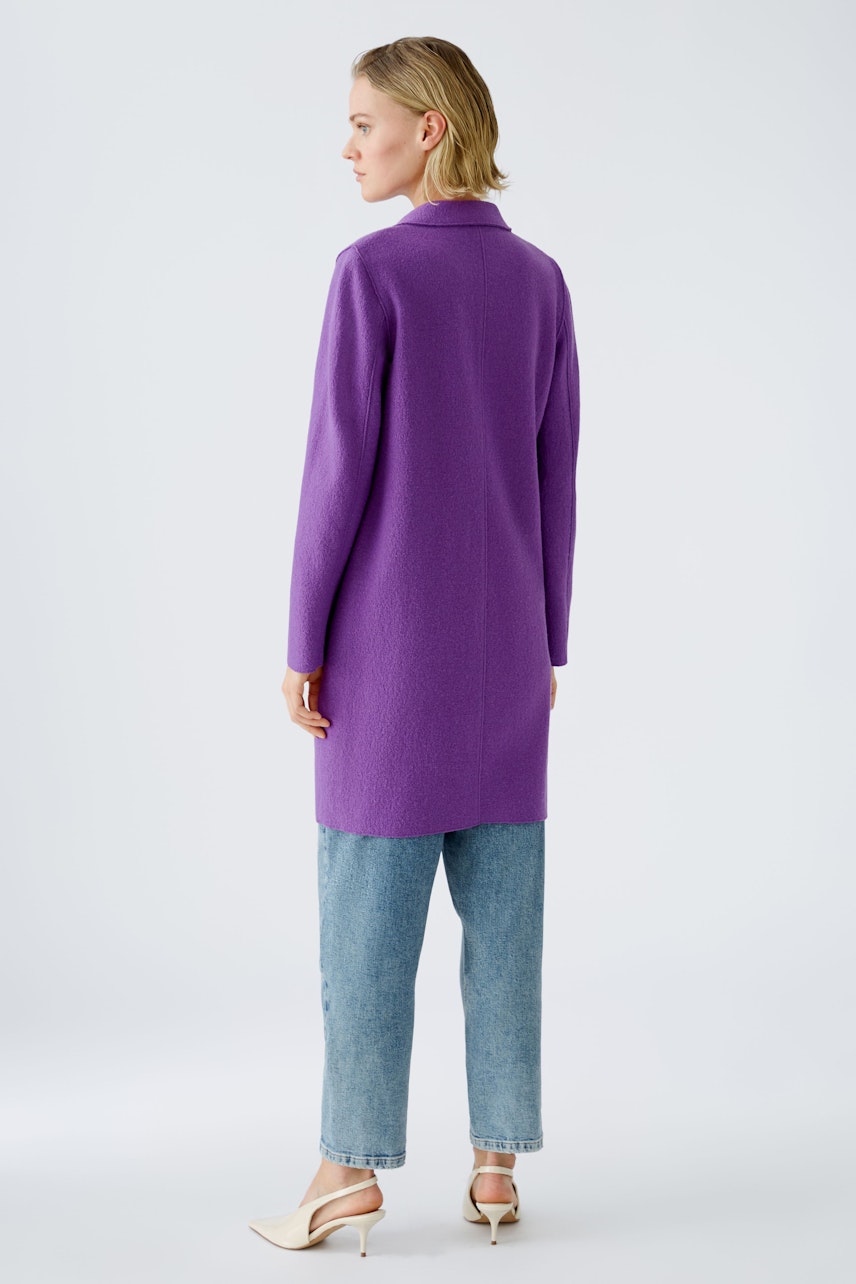 Stylish women's wool coat in vibrant purple, featuring a modern design and relaxed fit.