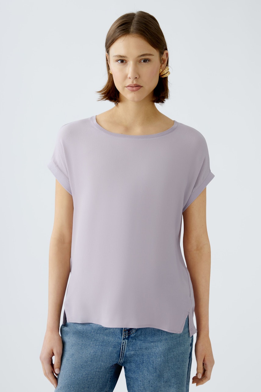 Stylish women's blouse shirt in soft lavender, featuring rolled sleeves and a relaxed fit.