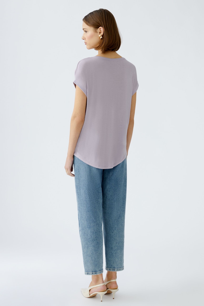 Stylish women's blouse shirt in soft lavender, paired with relaxed denim pants.