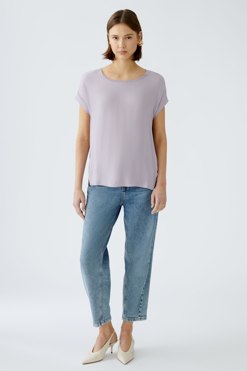 Light purple blouse shirt: Woman in a relaxed fit top paired with jeans, exuding effortless style.