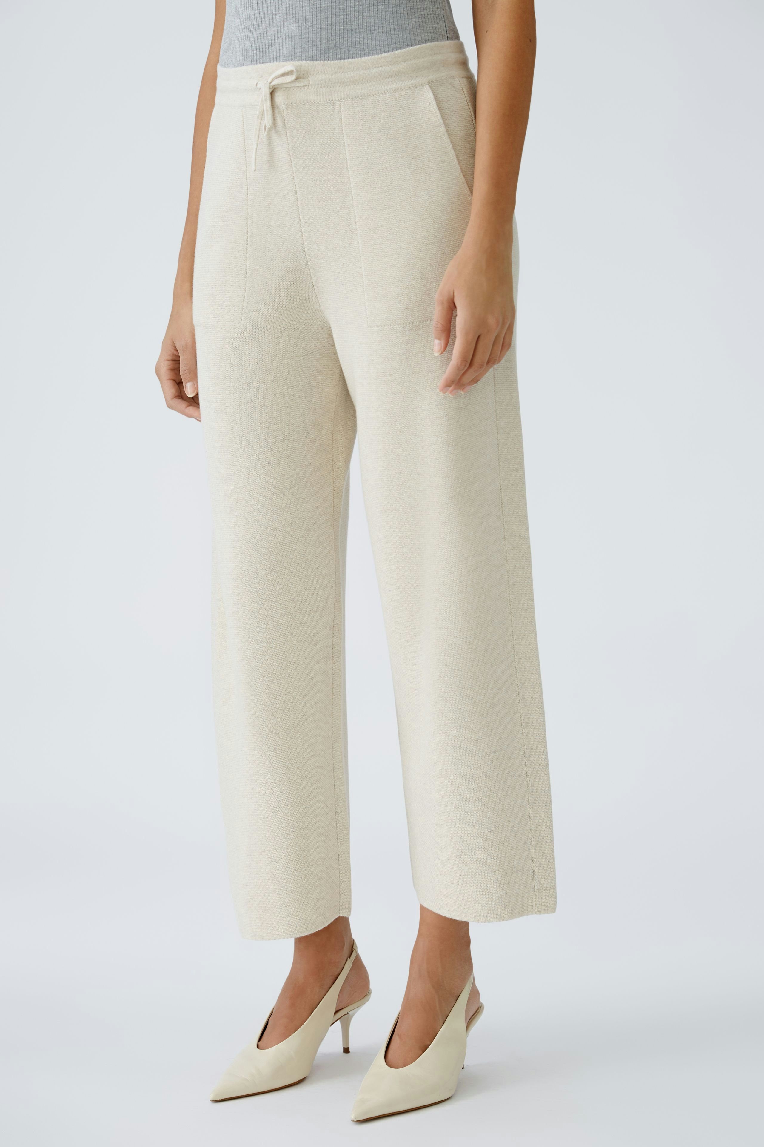 Chic women's knit pants in soft beige, featuring a relaxed fit and drawstring waist.