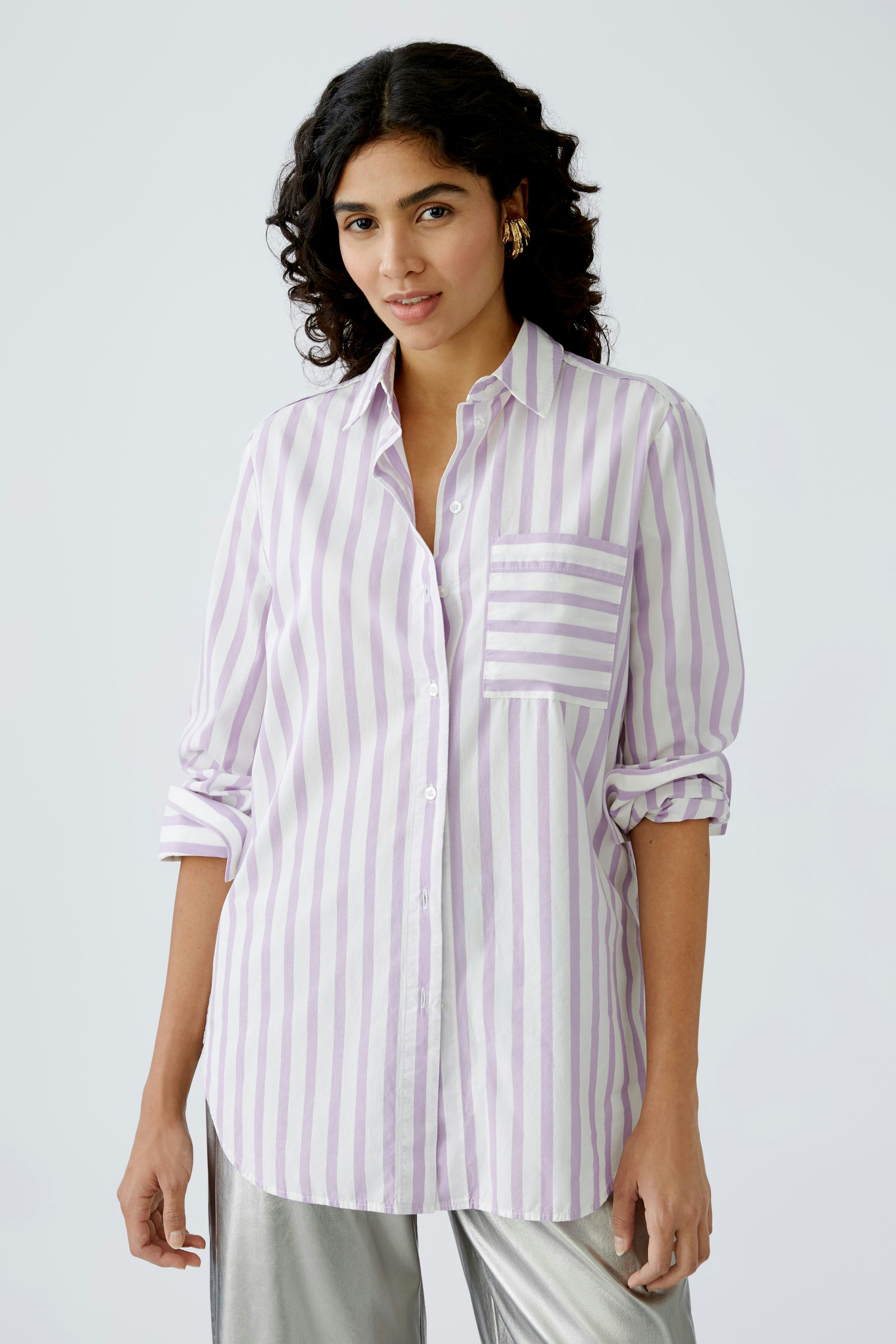 Stylish women's blouse: A woman in a light purple striped blouse with a pocket, exuding casual elegance.