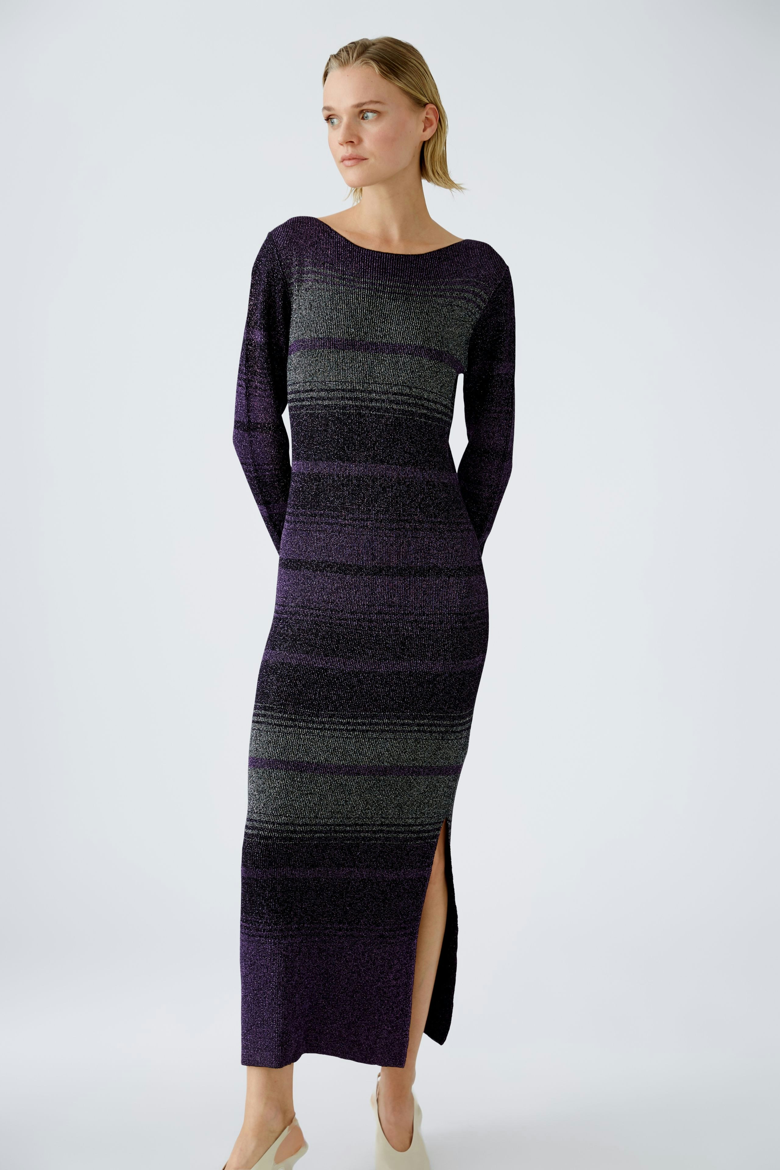 Elegant women's knitted dress in purple with stripes, featuring a side slit for a modern touch.