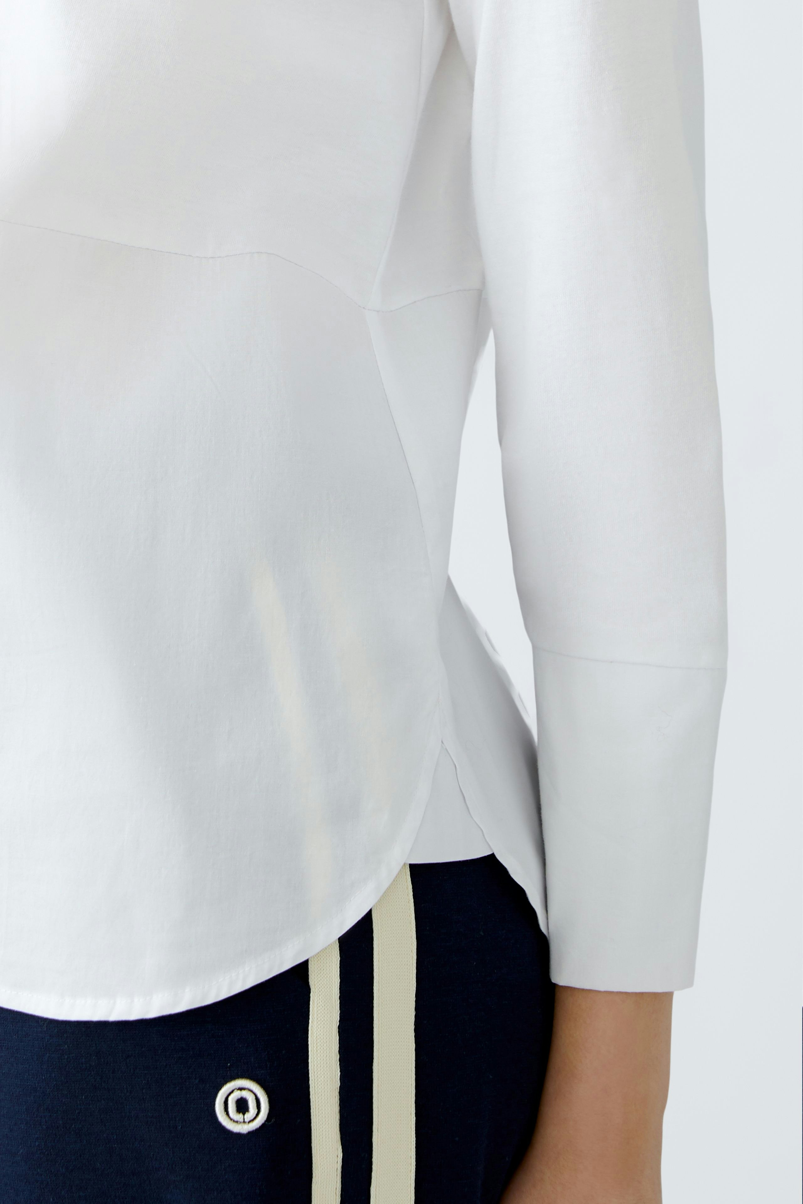 Elegant women's blouse shirt in white, featuring a stylish design and comfortable fit.
