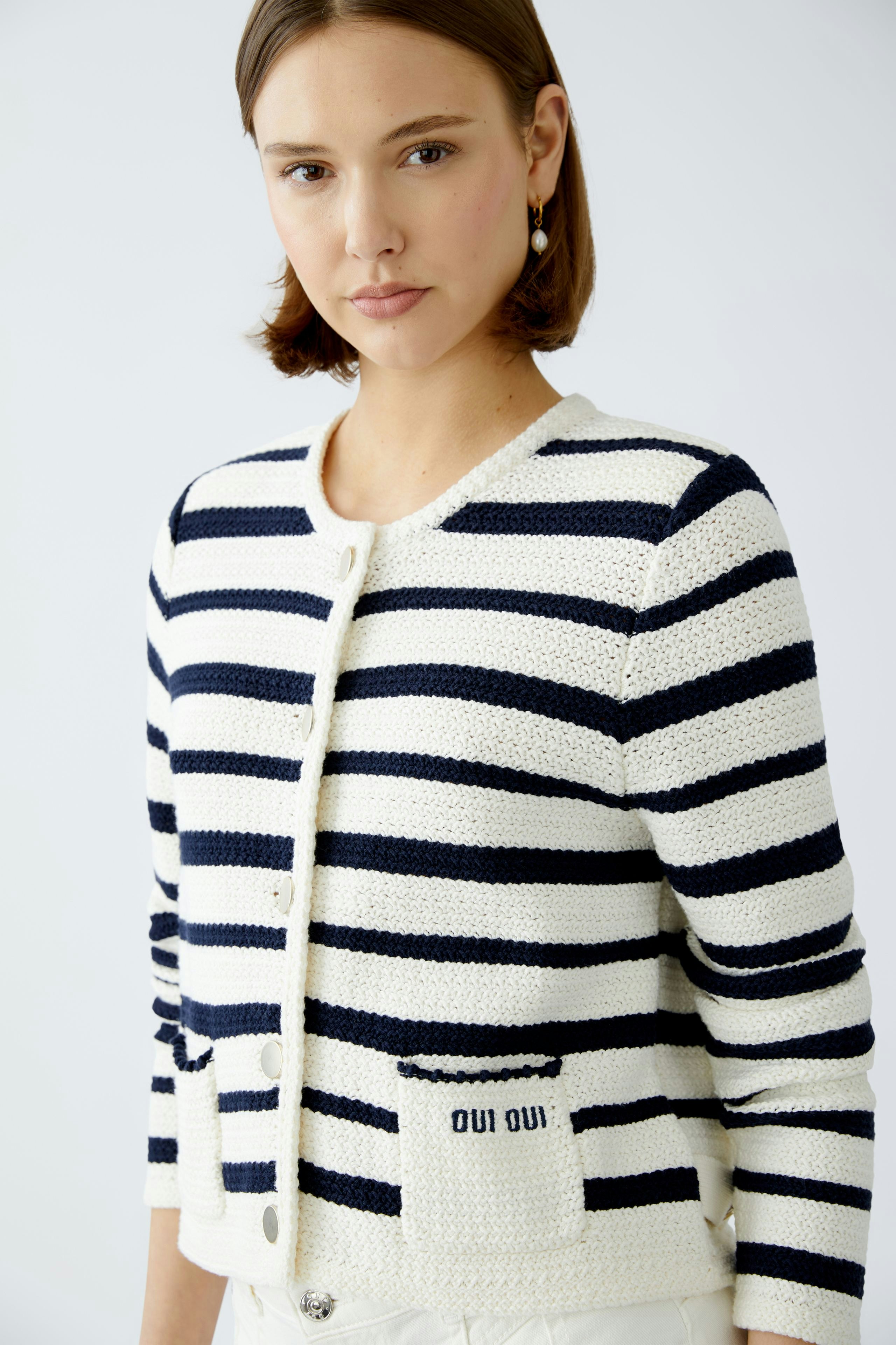 Stylish women's cardigan: A woman in a striped cardigan with pockets, exuding casual elegance.