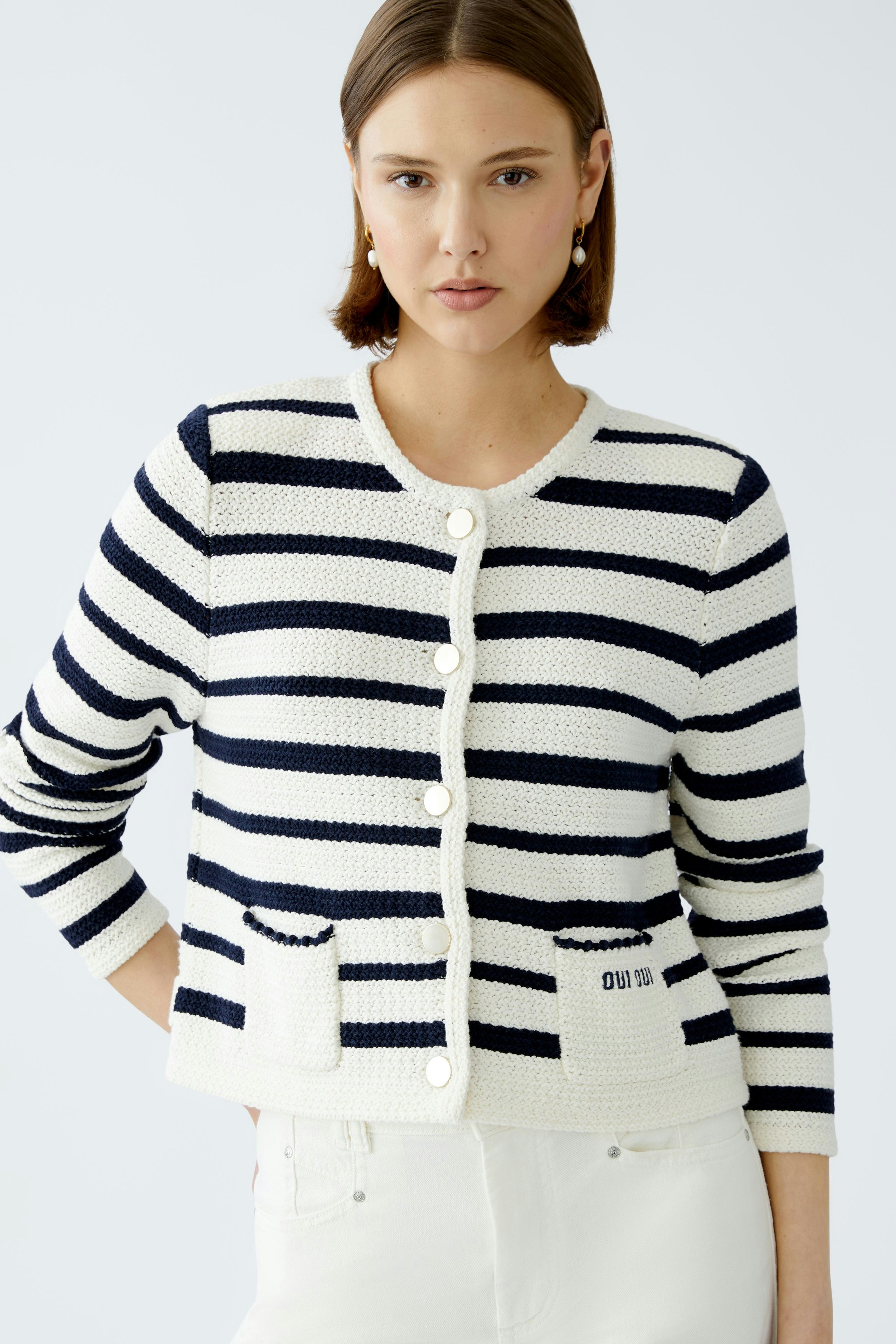 Stylish women's cardigan: A woman in a striped pullover with buttons and pockets, exuding casual elegance.
