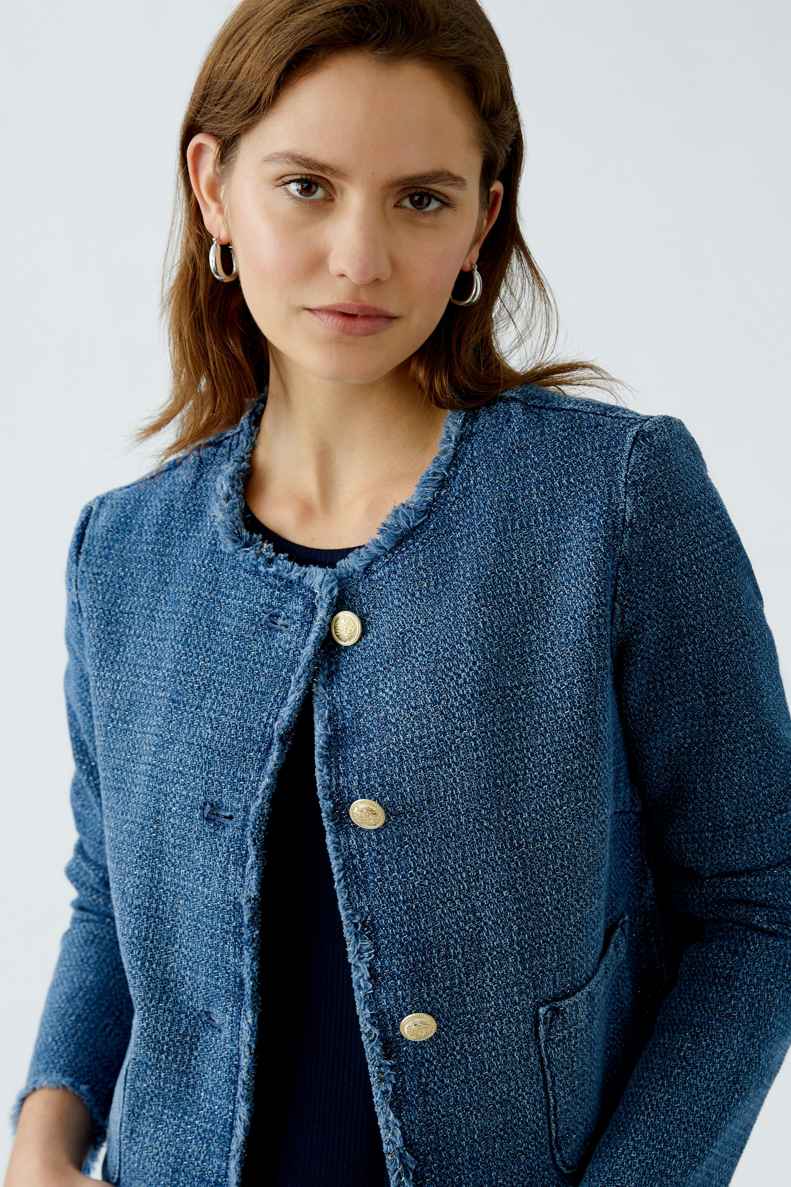 Stylish women's jacket in blue with gold buttons and a textured finish, perfect for any occasion.