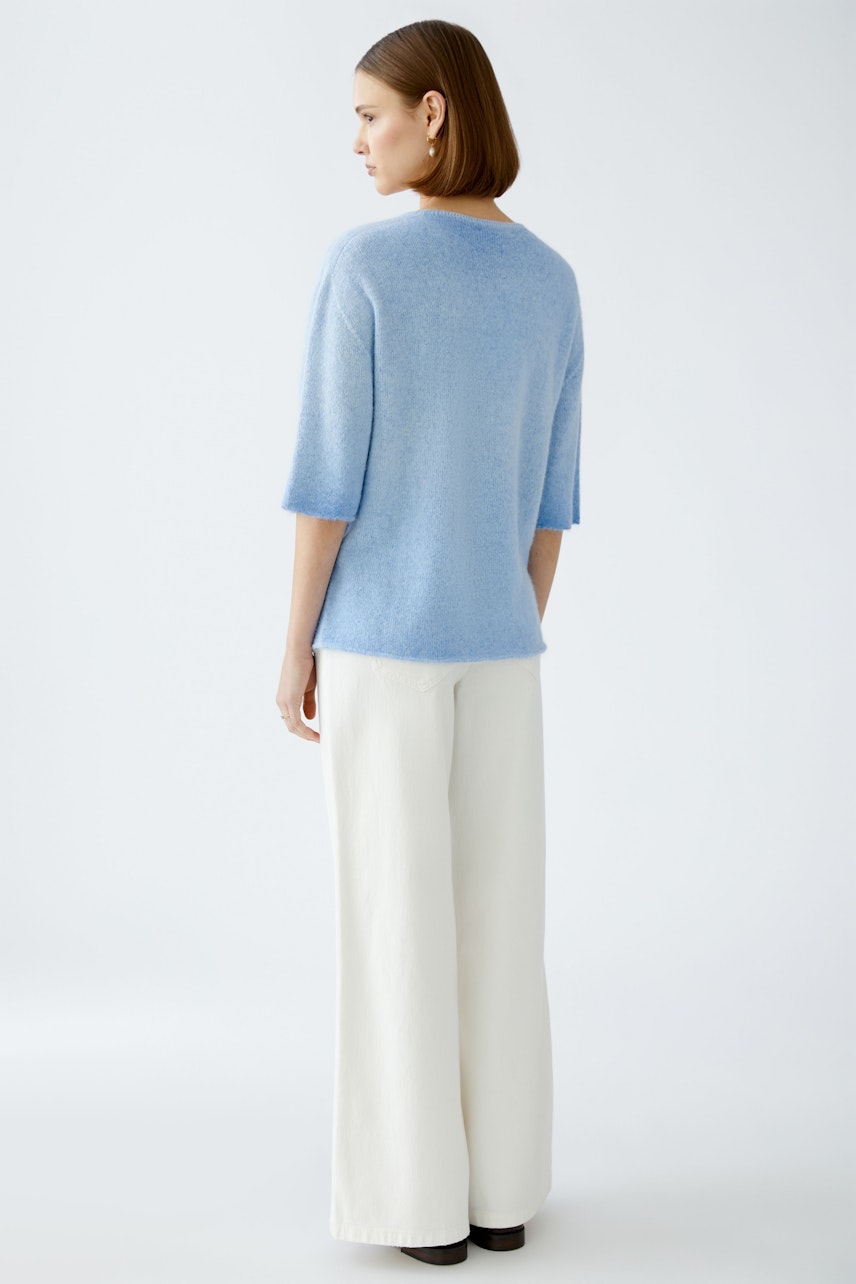 Stylish women's pullover in soft blue, featuring a relaxed fit and short sleeves.