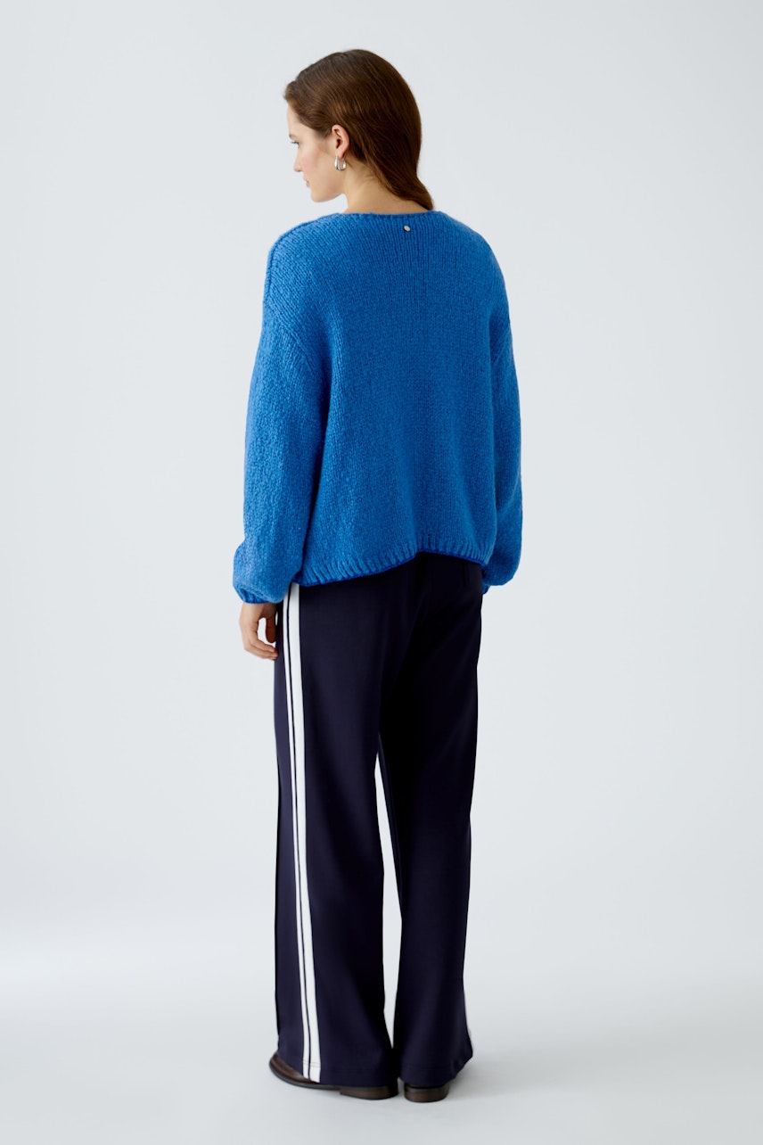 Cozy women's cardigan in vibrant blue, featuring a relaxed fit and soft texture.