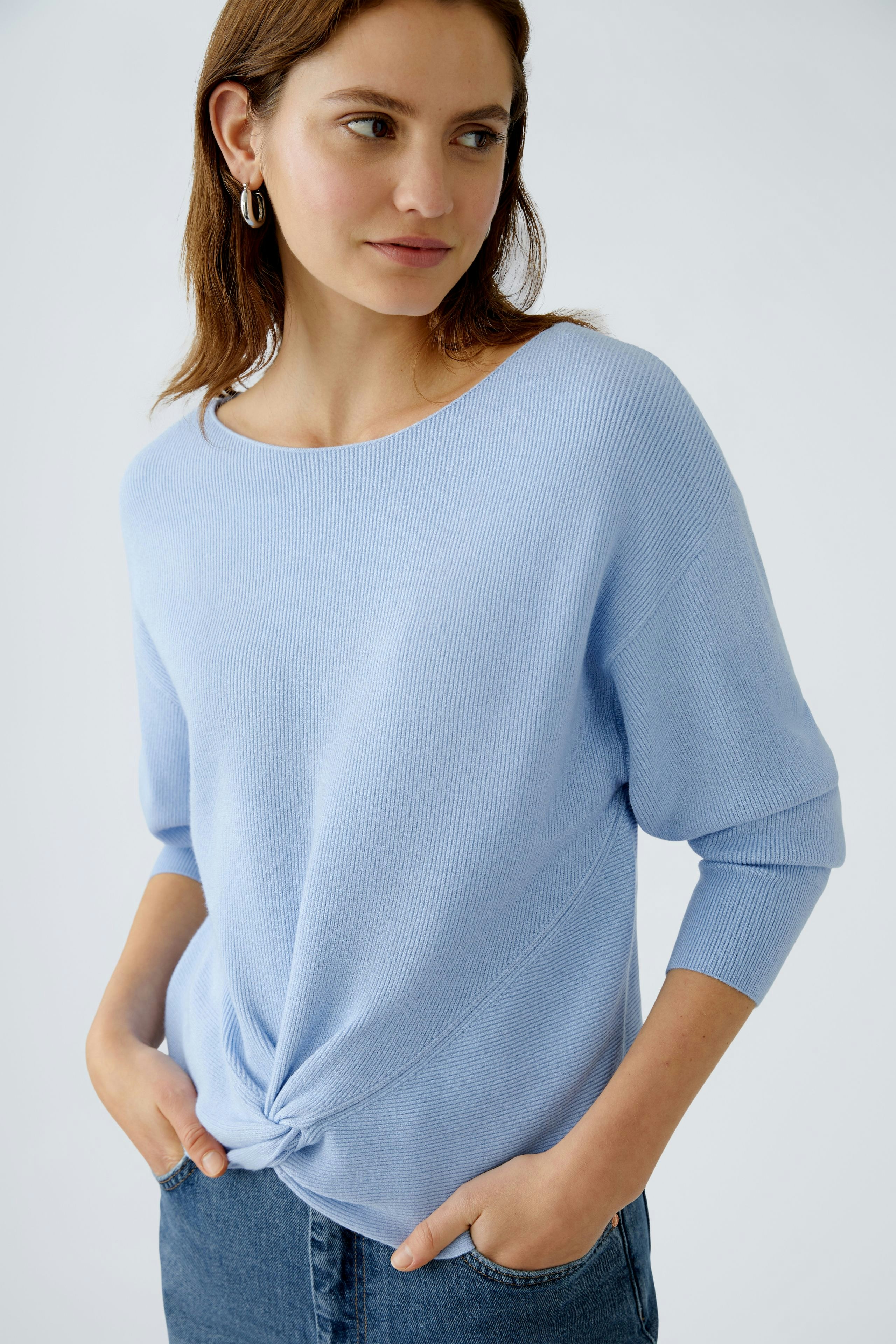 Stylish women's pullover in light blue, featuring a knotted front detail and relaxed fit.