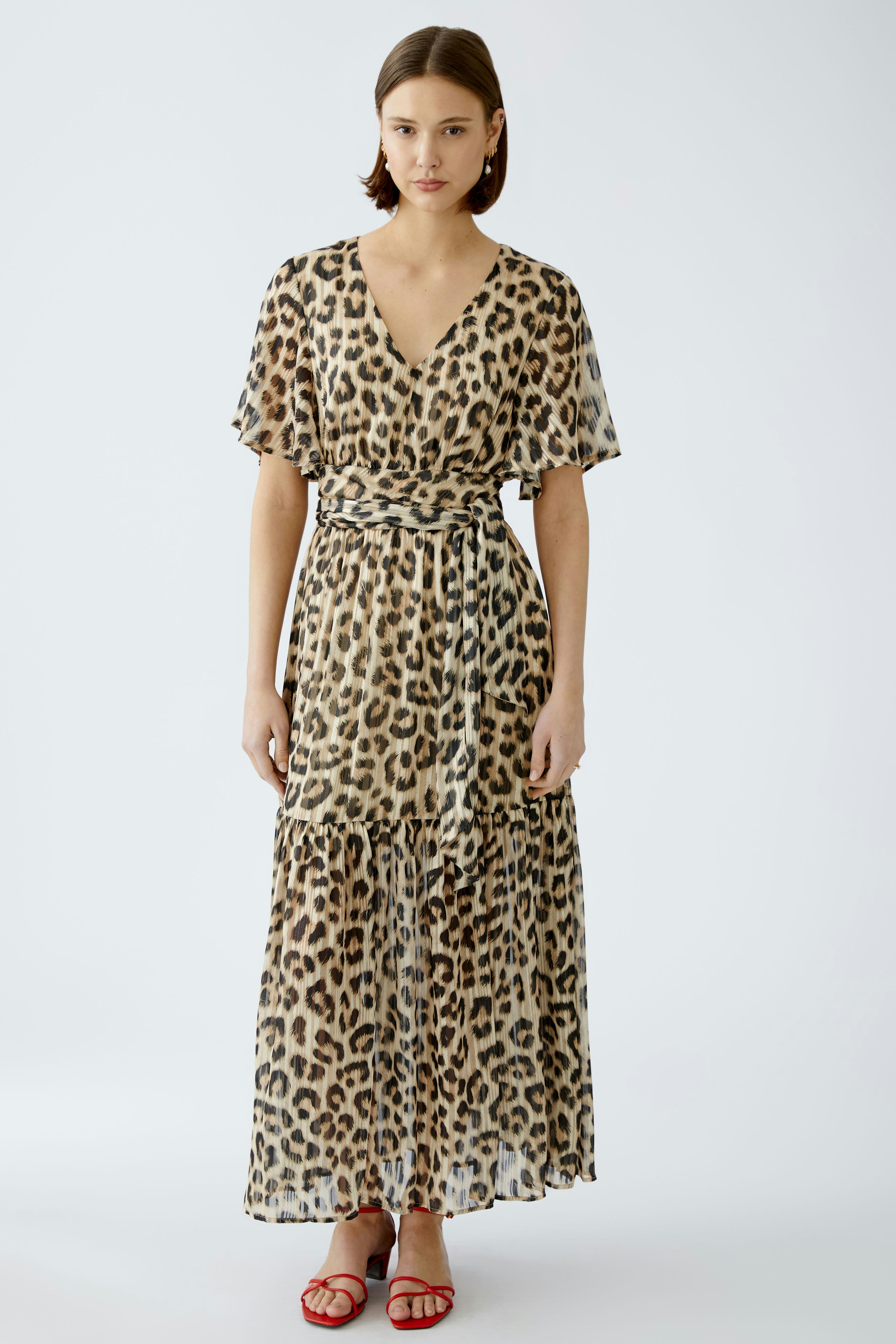 Elegant maxi dress: A woman in a flowing leopard print dress with a flattering silhouette.