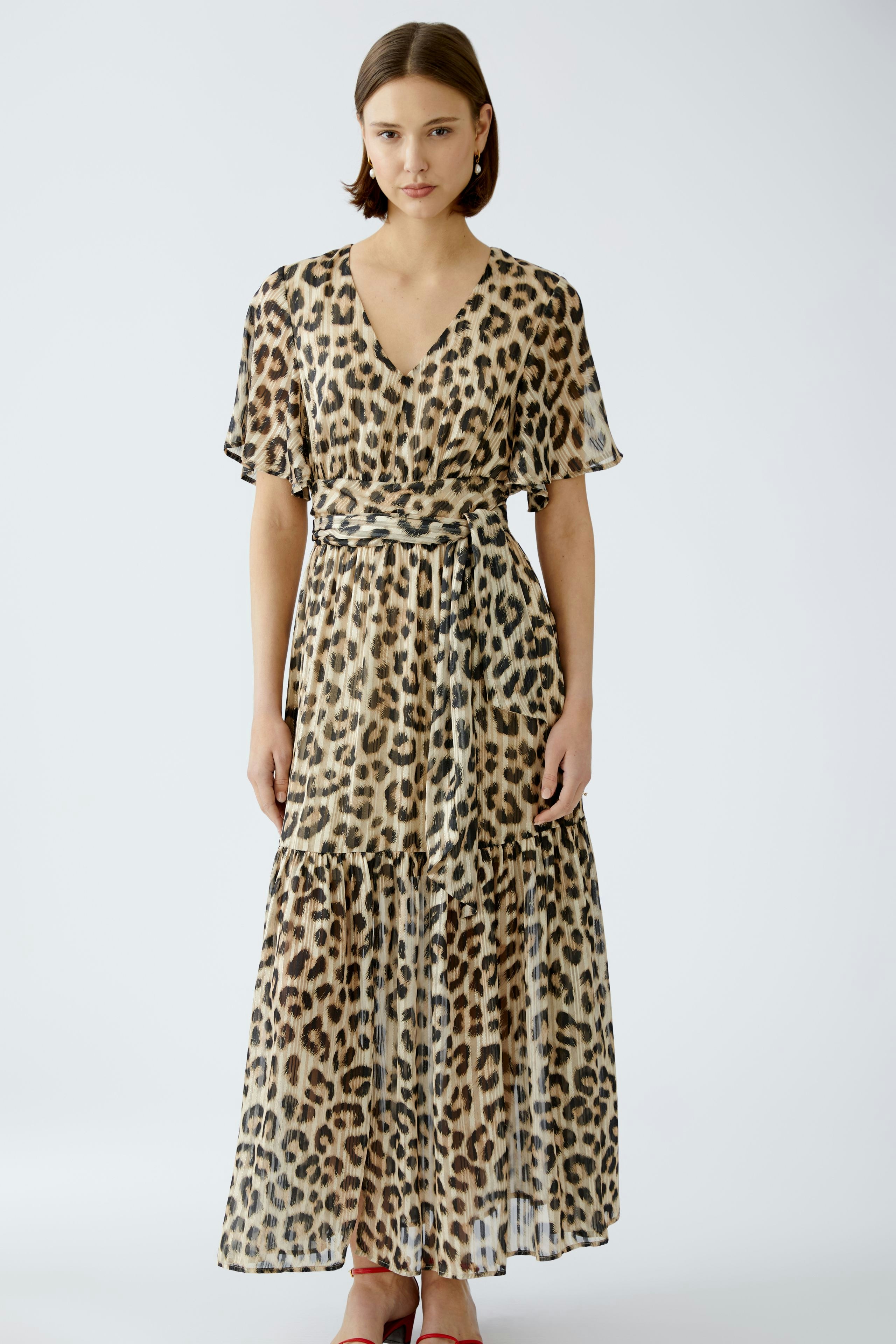 Elegant maxi dress: A woman in a flowing leopard print dress with a flattering silhouette.