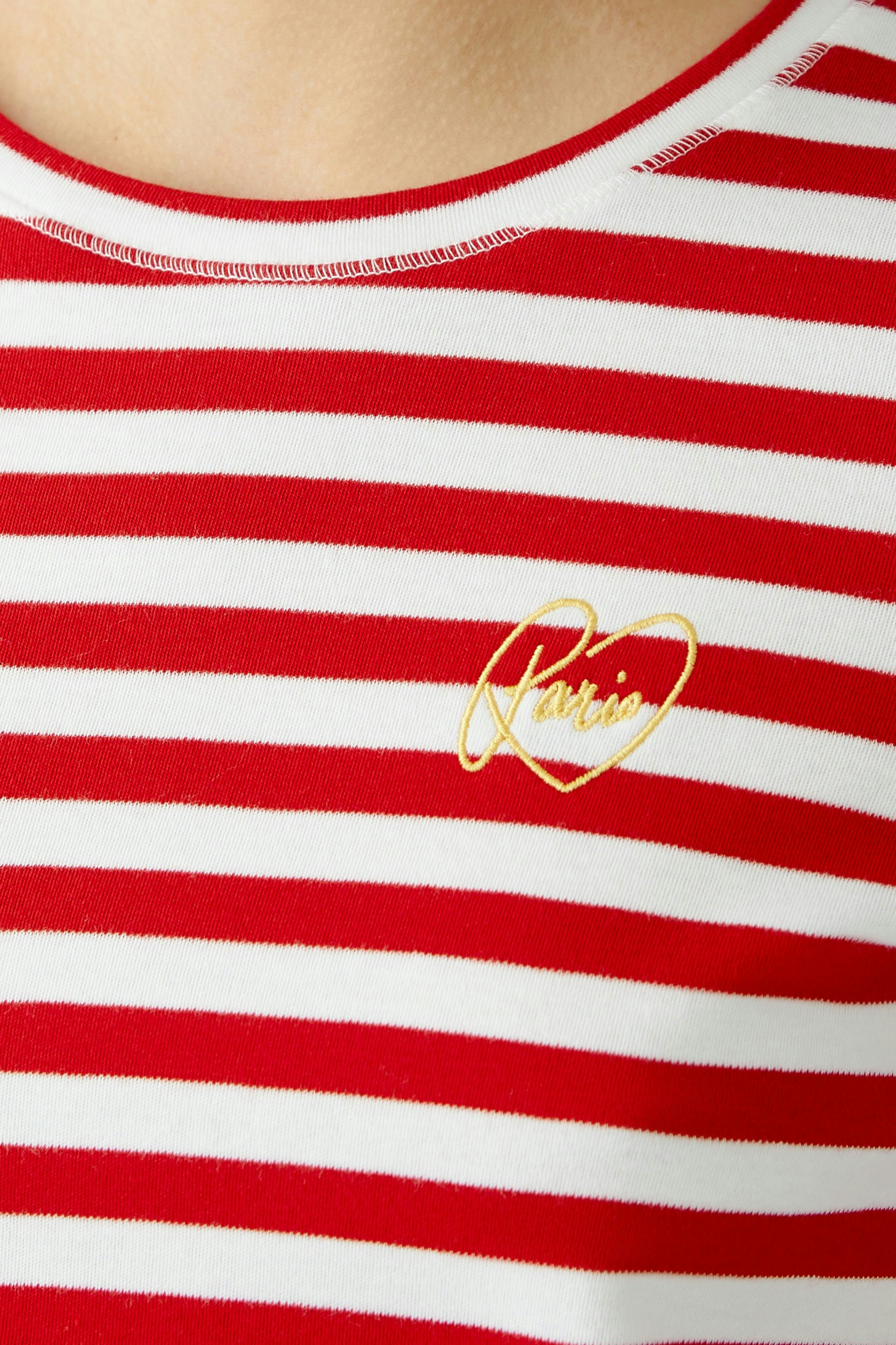 Stylish women's T-shirt: Close-up of a woman in a red and white striped tee with a golden heart logo.