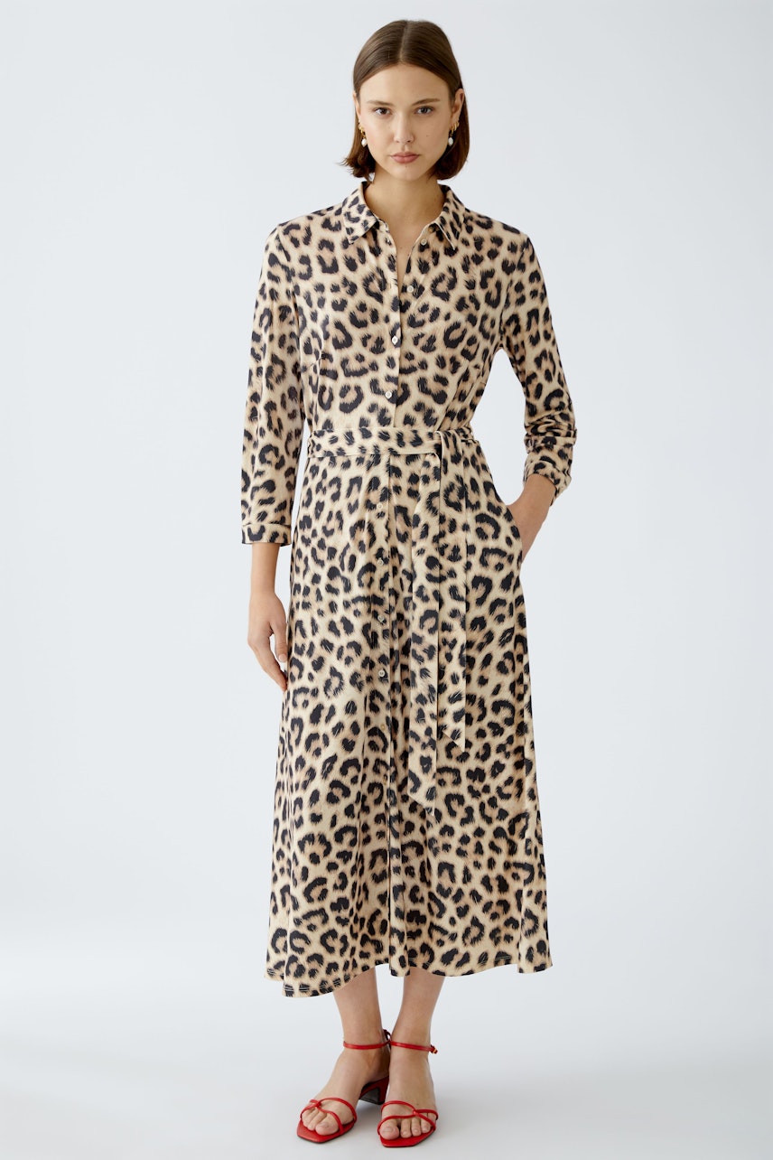 Chic shirt dress: A woman in a leopard print shirt dress with a flattering silhouette and stylish details.