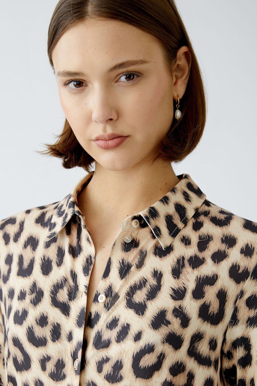 Stylish shirt dress: A woman in a leopard print shirt dress exudes confidence and elegance.