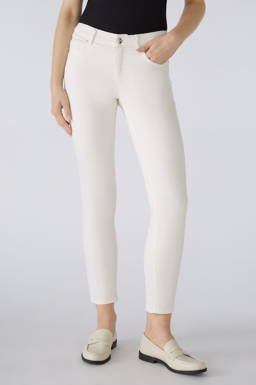 Stylish jeggings for women: A woman in white jeggings paired with loafers, showcasing a sleek fit.