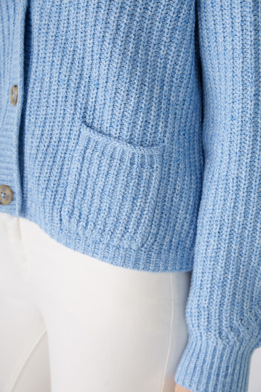 Stylish women's cardigan in soft blue with textured knit and practical pockets.