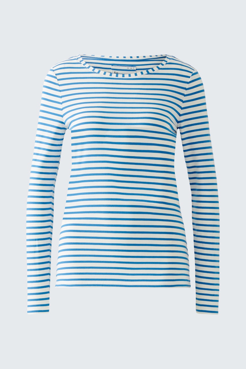 Stylish long-sleeve shirt: A woman in a blue and white striped pullover, exuding casual elegance.