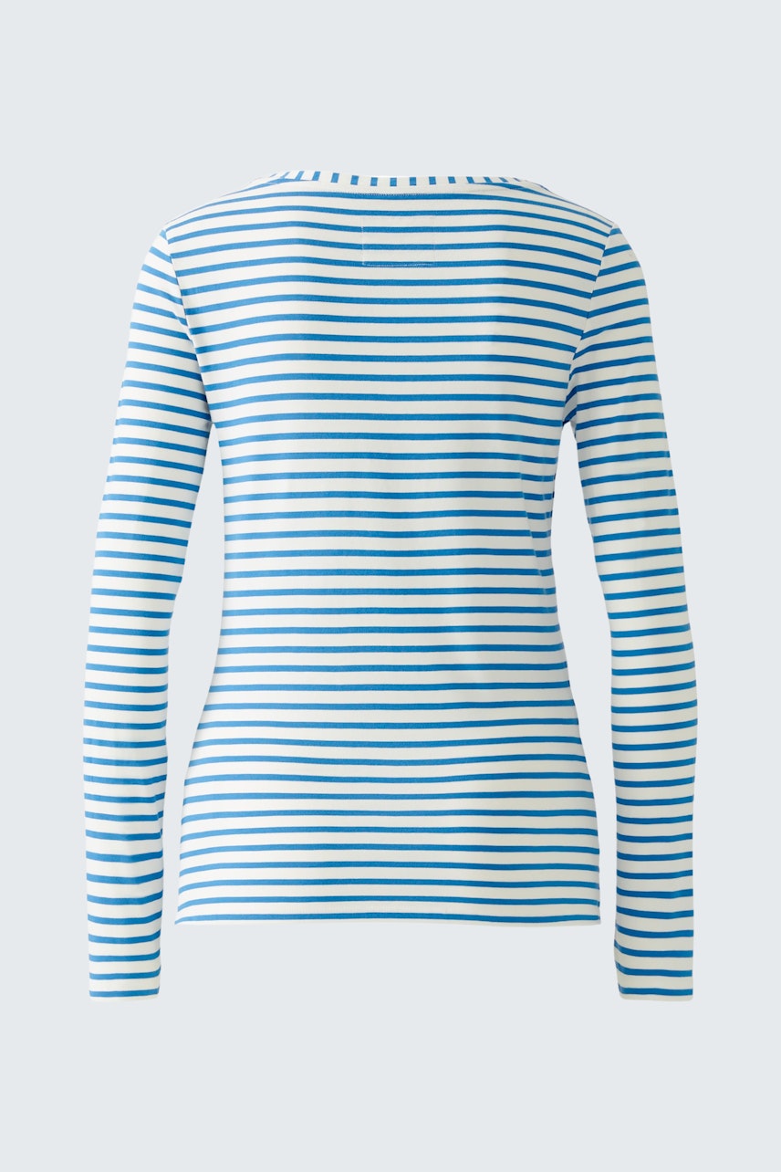 Stylish long-sleeve shirt: A woman in a blue and white striped pullover, showcasing a casual look.