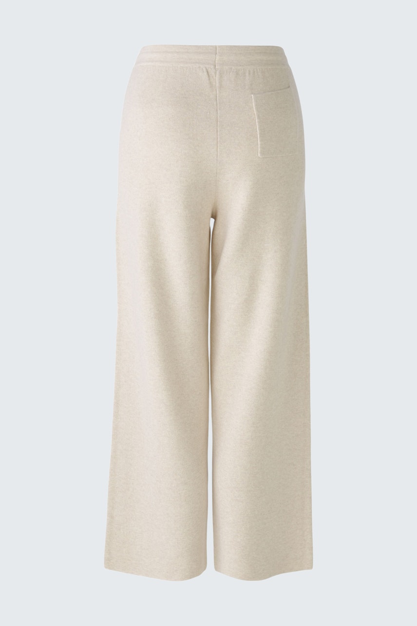 Chic women's knit pants in soft beige, perfect for casual and comfortable styling.