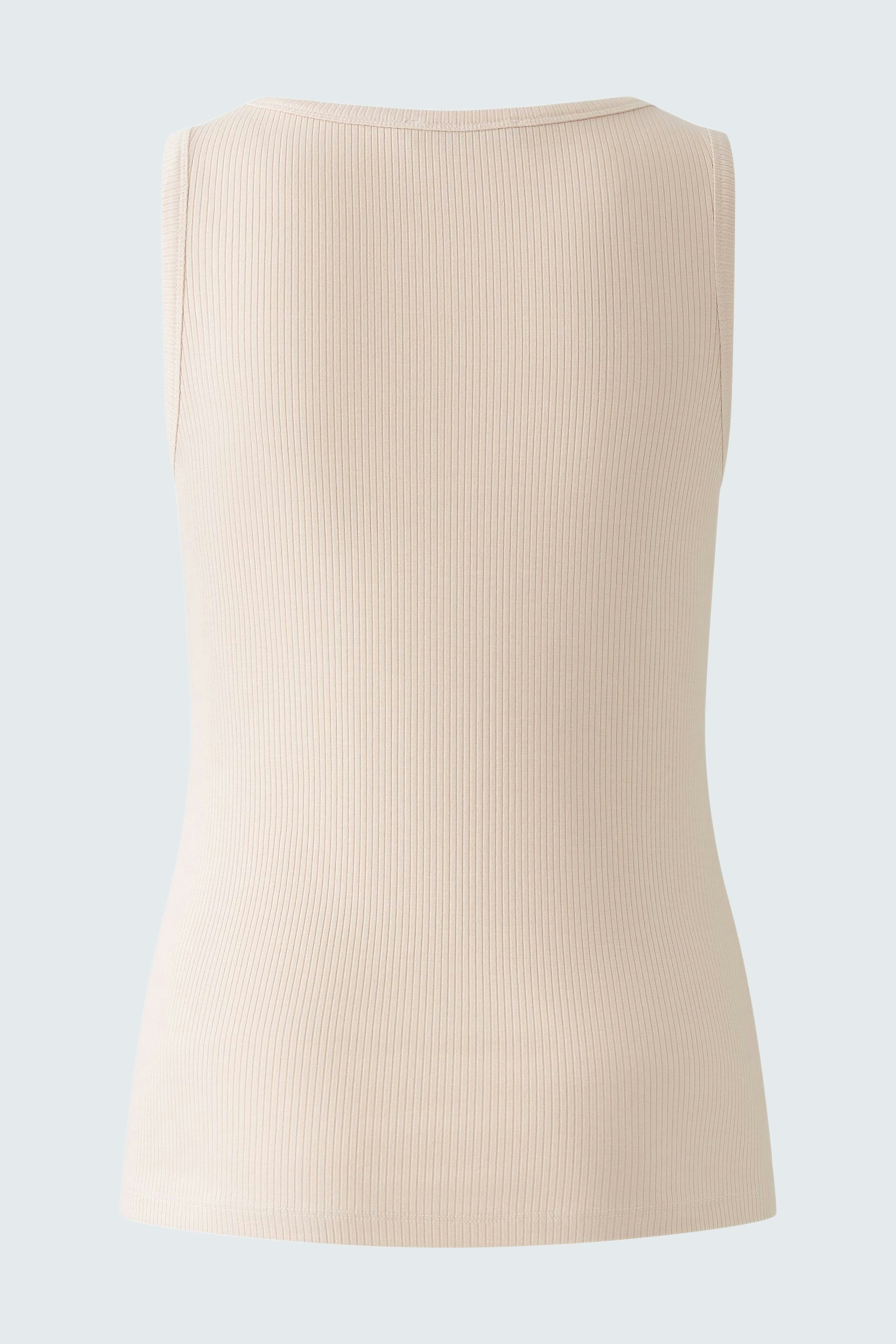 Elegant women's top: A fitted, light beige sleeveless top with a ribbed texture.