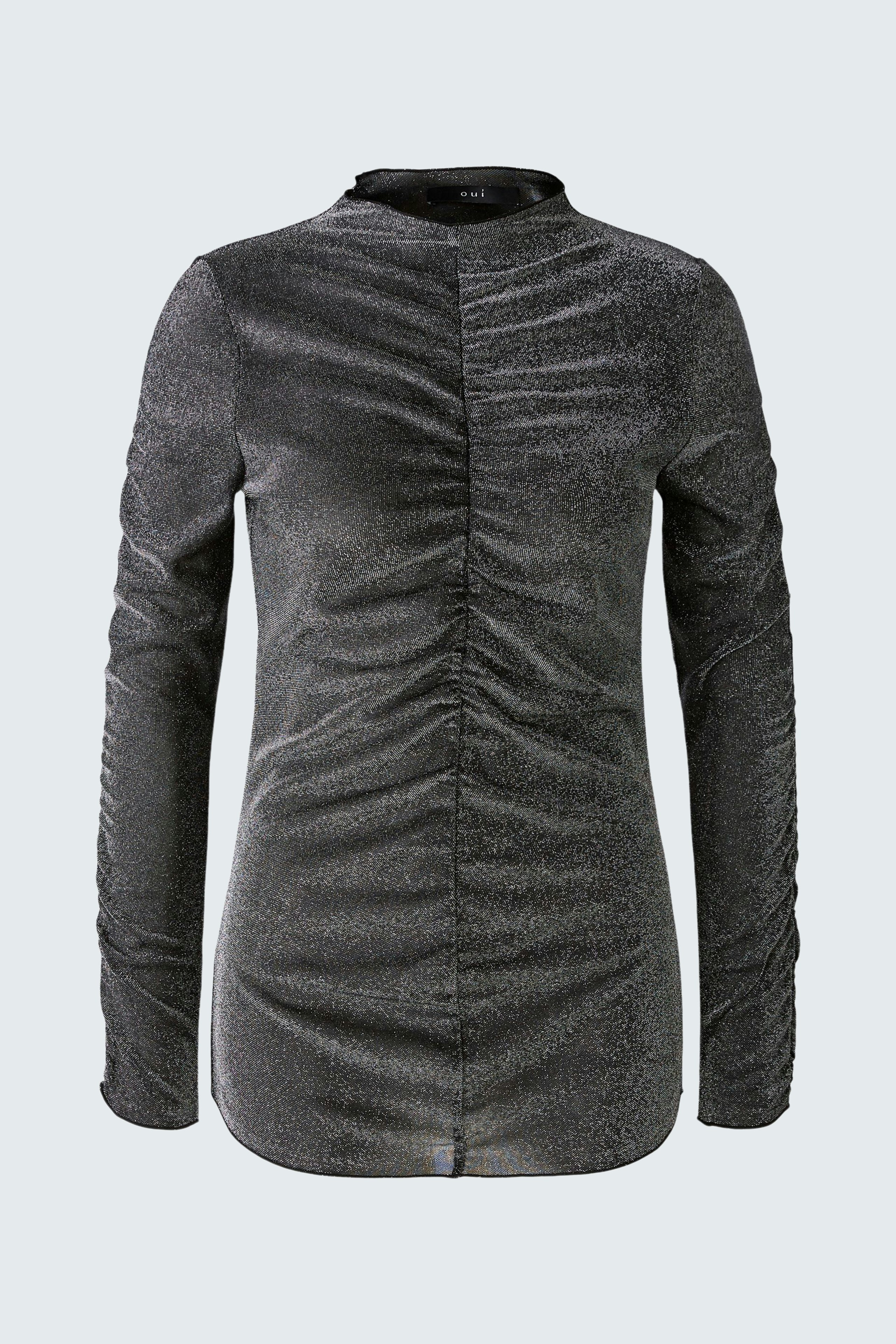 Stylish long-sleeve shirt: A woman in a fitted black pullover with elegant ruching detail.
