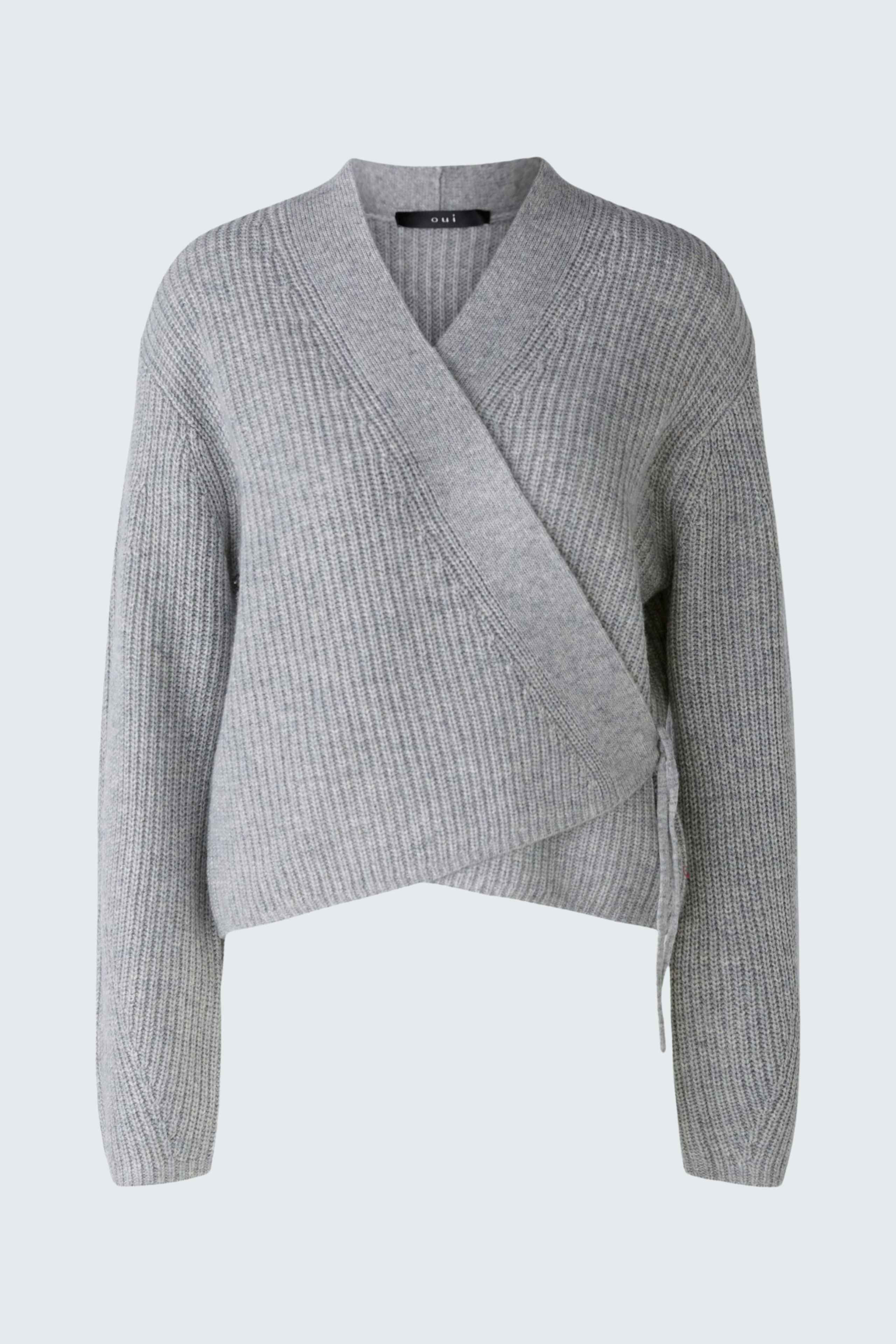 Stylish women's pullover: A woman in a light gray wrap pullover with ribbed texture, exuding elegance.