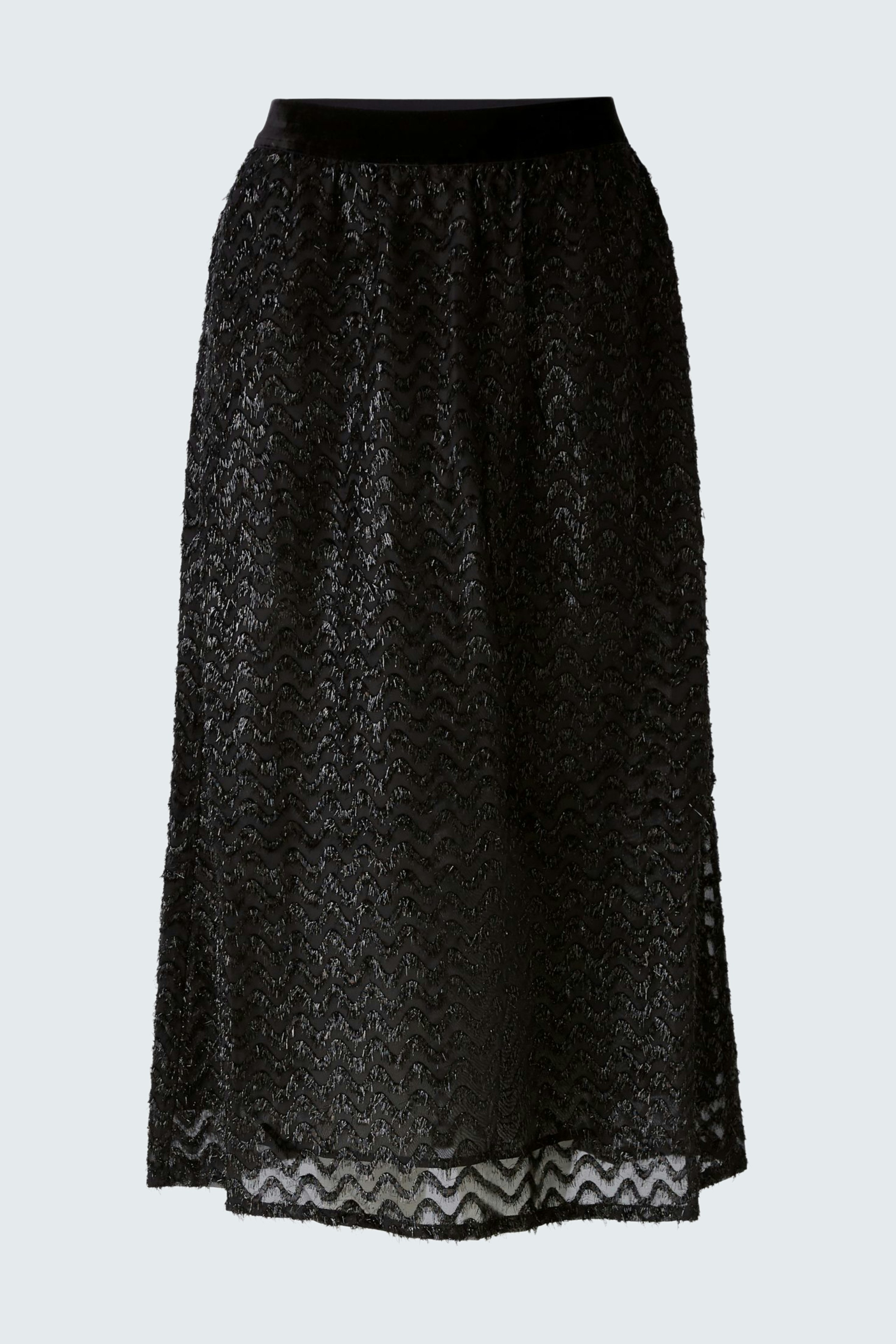 Elegant black skirt: Woman in a flowing black skirt with a delicate pattern, exuding sophistication.
