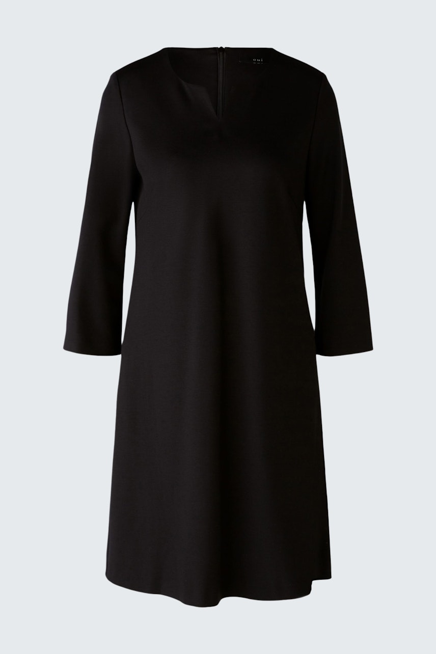 Elegant black dress: A woman in a sleek, knee-length dress with a subtle neckline, perfect for any occasion.