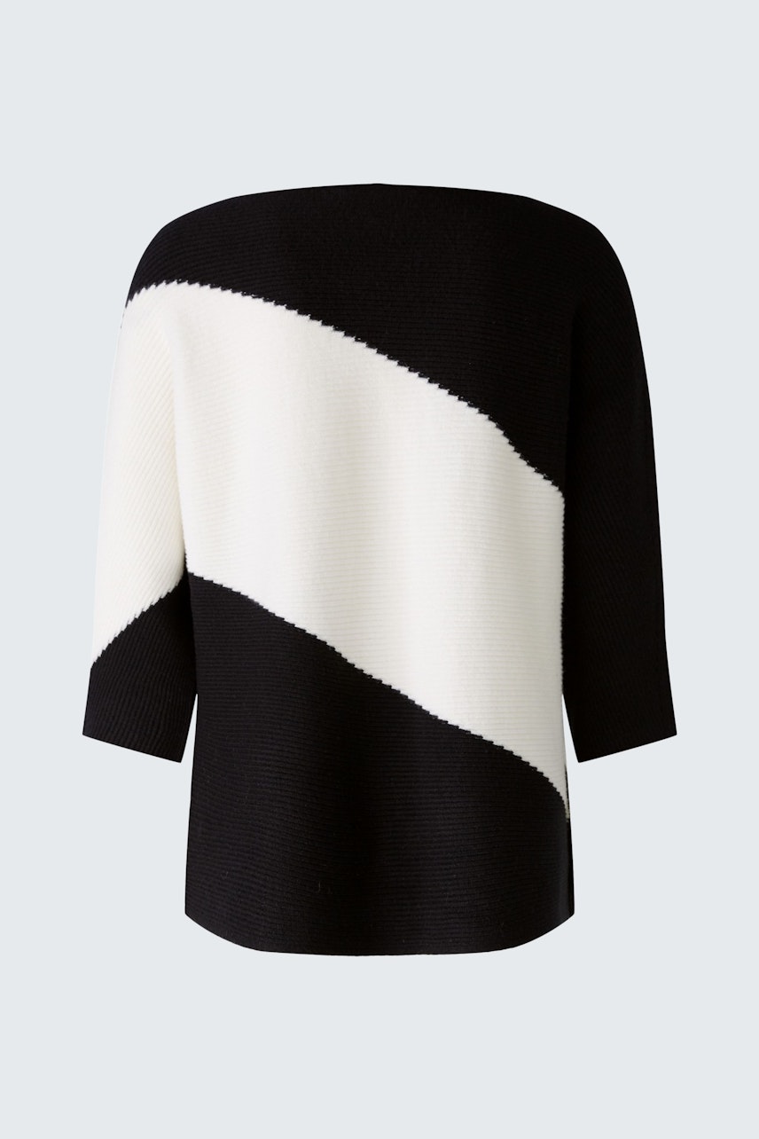 Stylish women's pullover in black and white with a modern diagonal design.