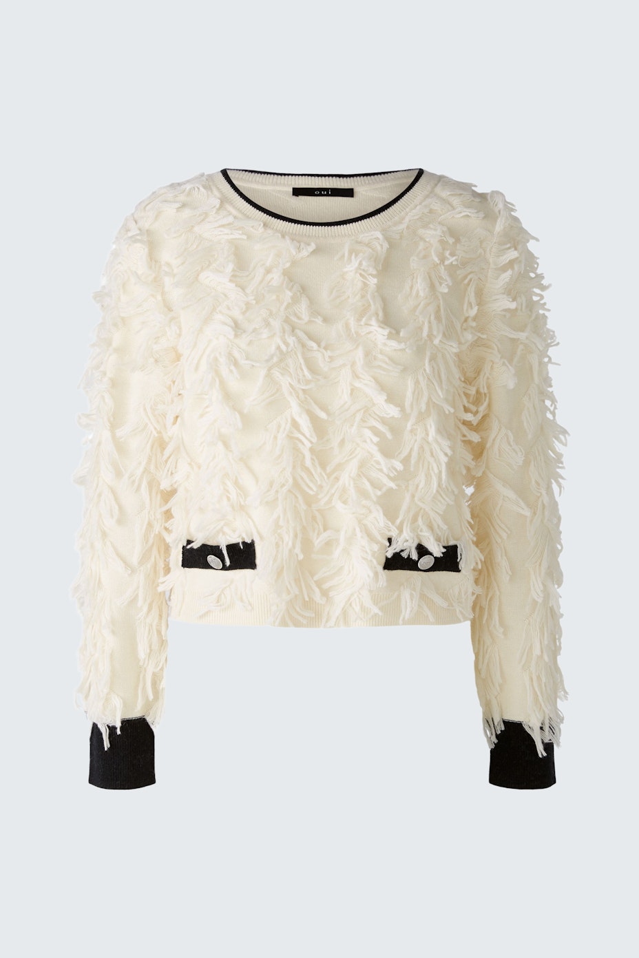 Stylish women's pullover: Cream-colored with textured ruffles and contrasting black cuffs.