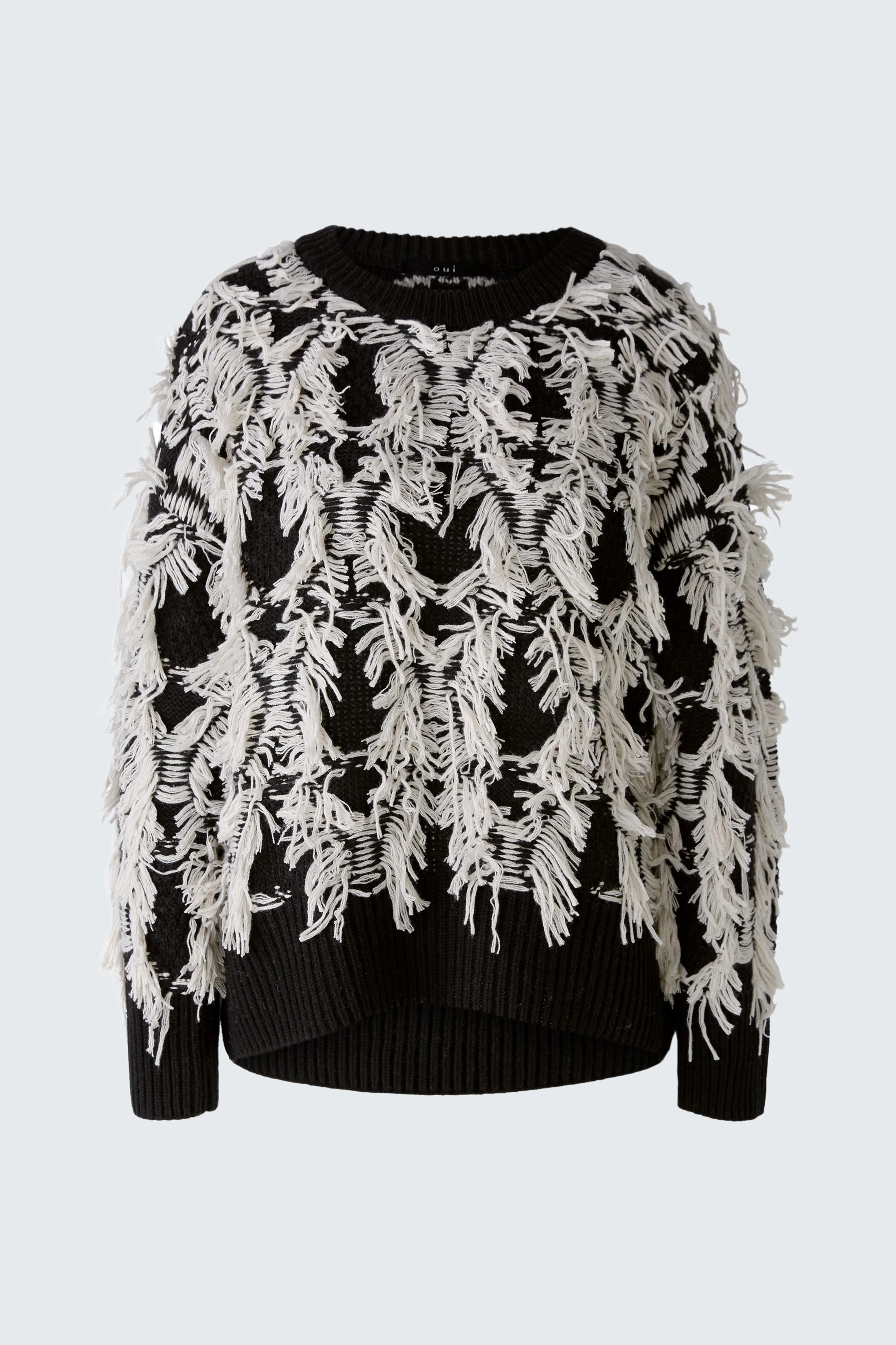Stylish pullover: Black pullover with white fringe detailing, perfect for a chic look.