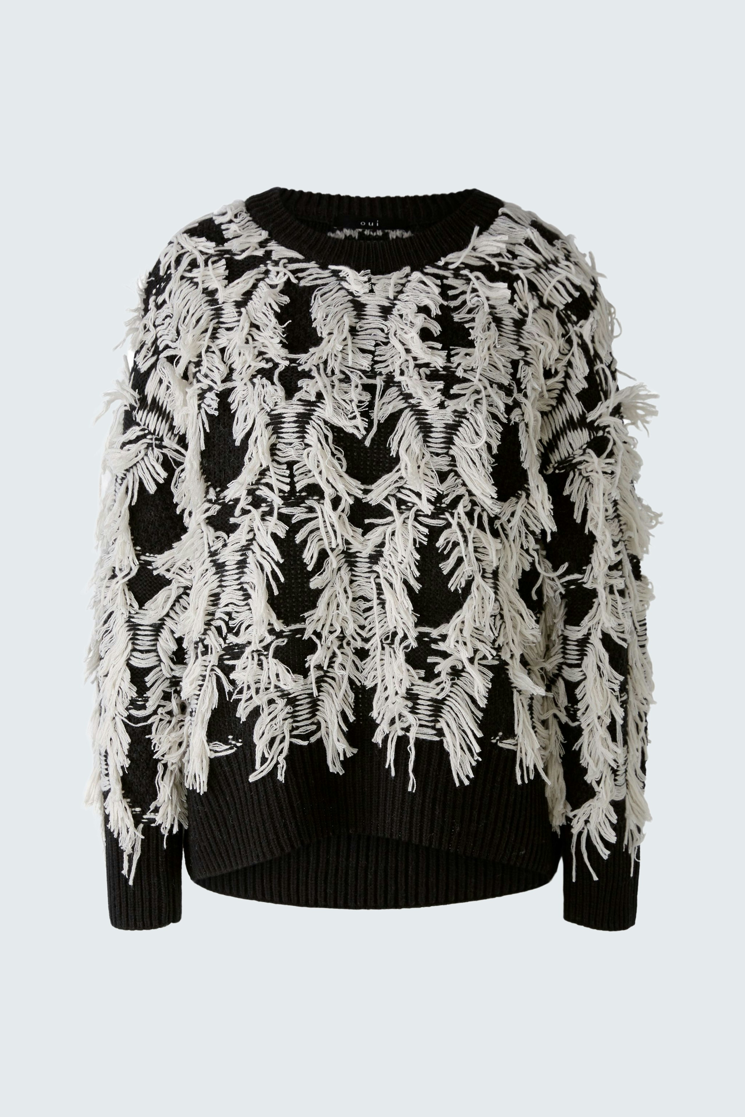 Stylish pullover: Black pullover with white fringe detailing, perfect for a chic look.