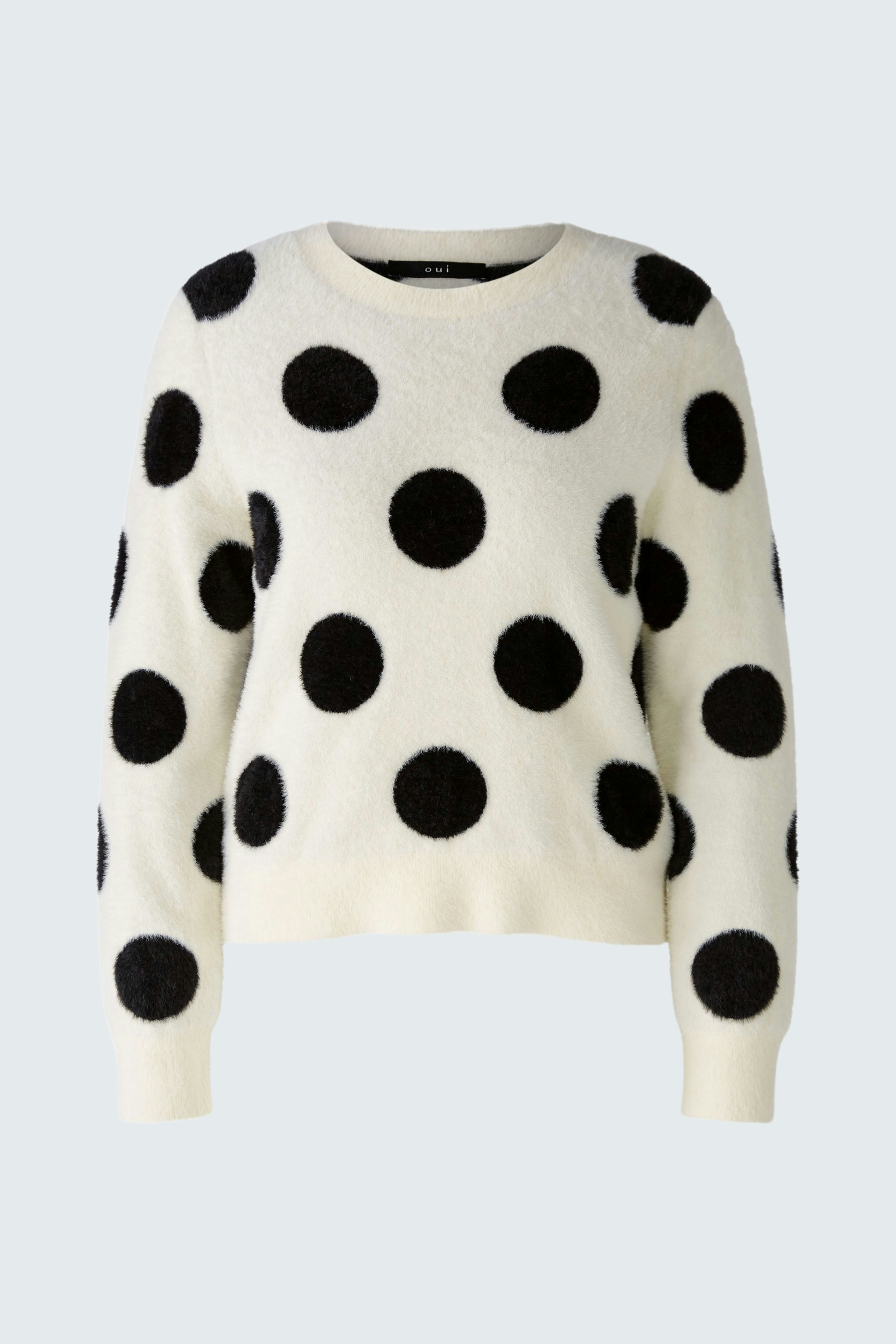 Klassischer Damen-Pullover in Creme mit schwarzen Punkten, ideal für einen lässigen Look.