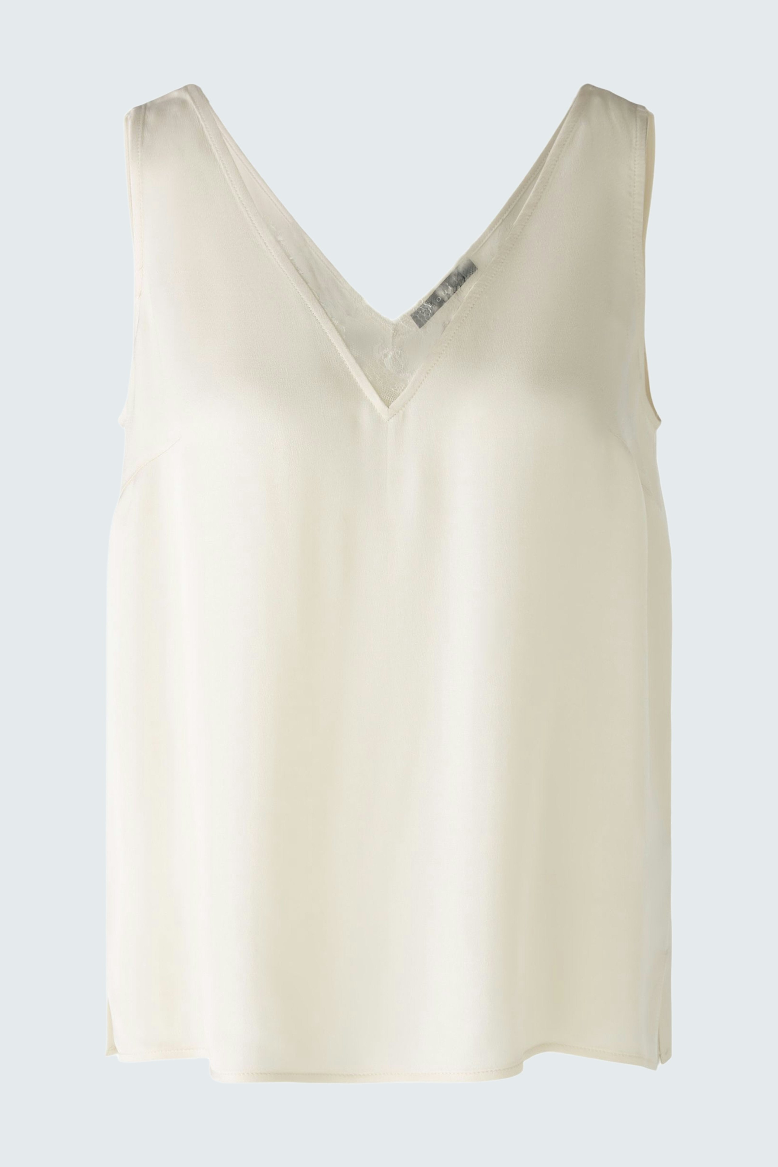 Elegant women's top: A light cream sleeveless top with a V-neck design, perfect for layering.
