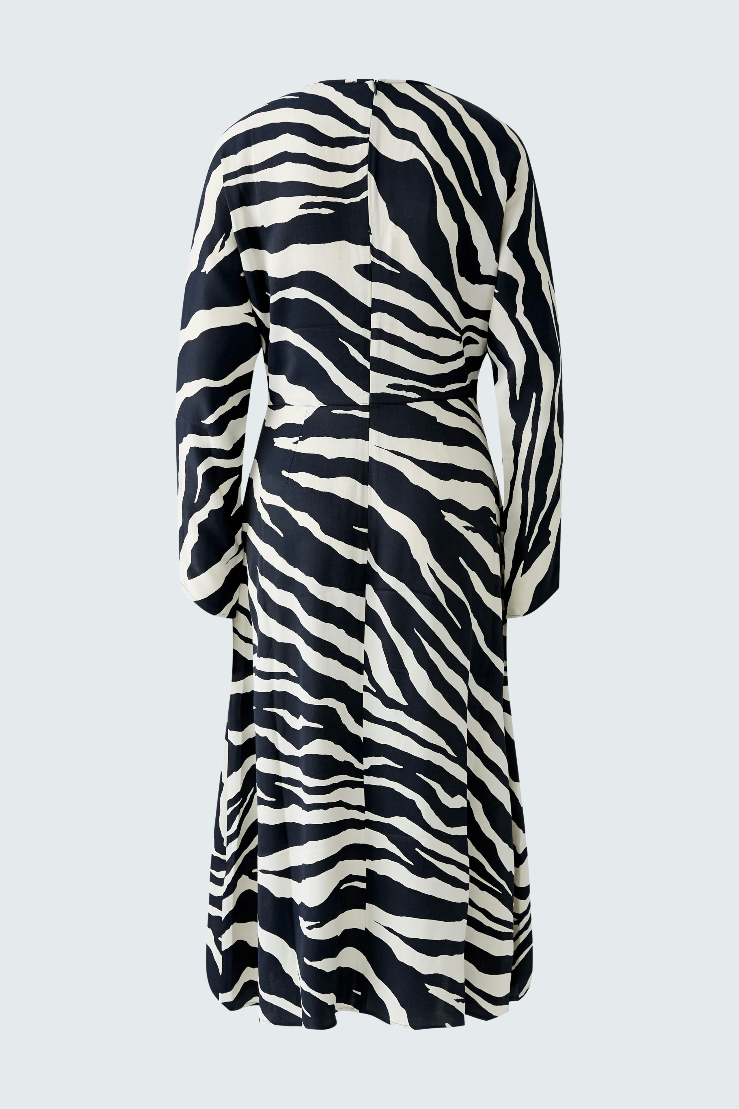 Stylish midi dress: A woman in a bold zebra-striped midi dress, showcasing a modern and elegant design.