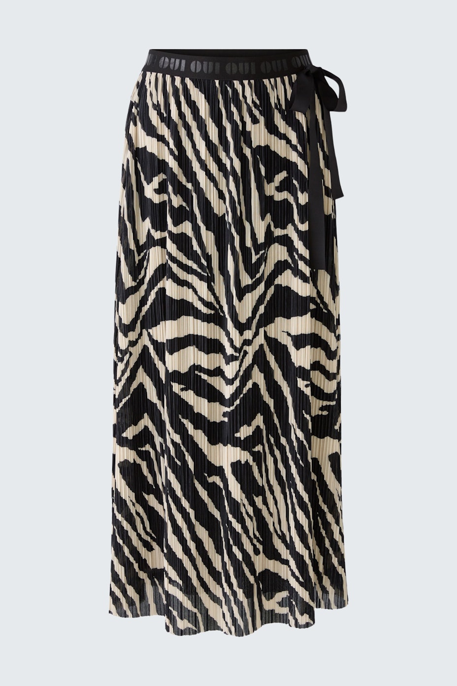 Stylish maxi skirt: A woman in a pleated black and white zebra print skirt with a comfortable waistband.