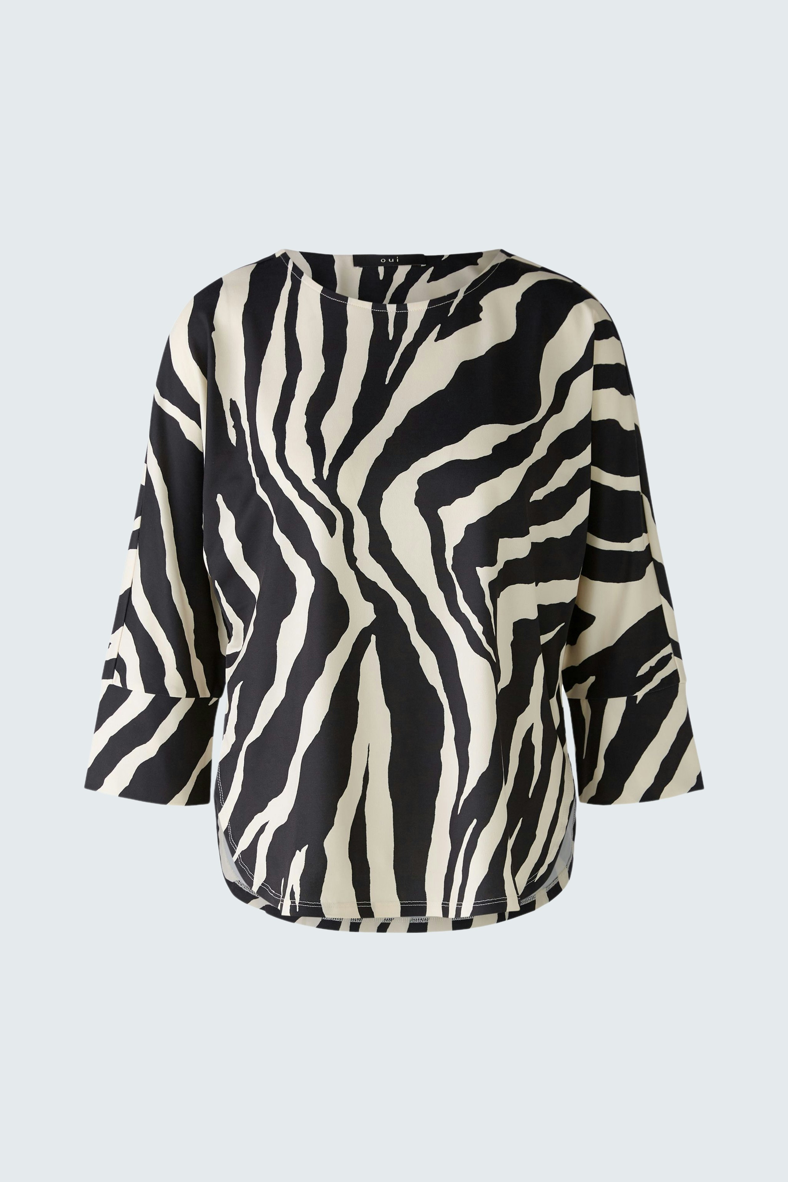 Stylish women's T-shirt in bold black and white zebra print, perfect for a trendy look.
