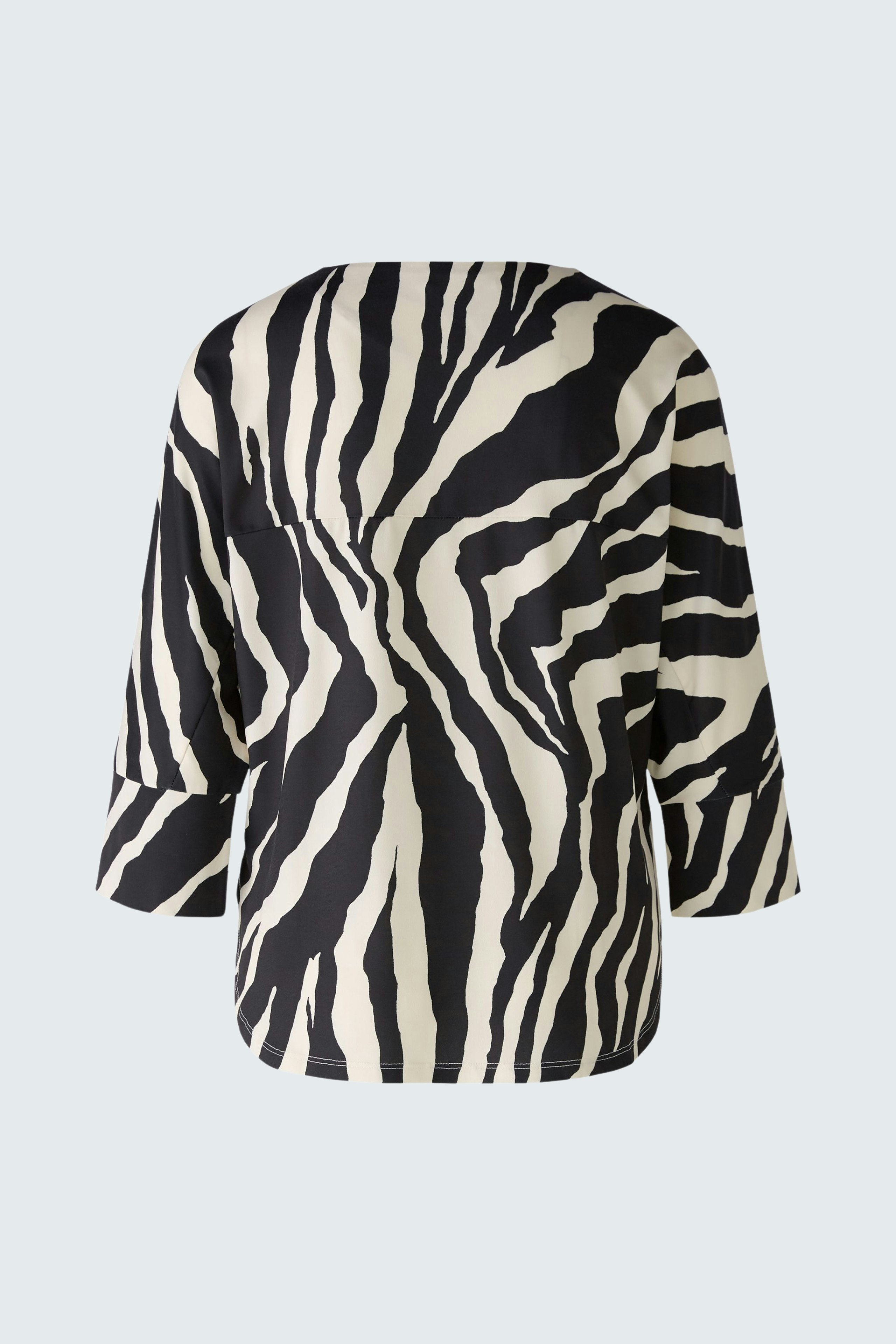 Stylish women's T-shirt in a bold zebra print, perfect for a trendy look.
