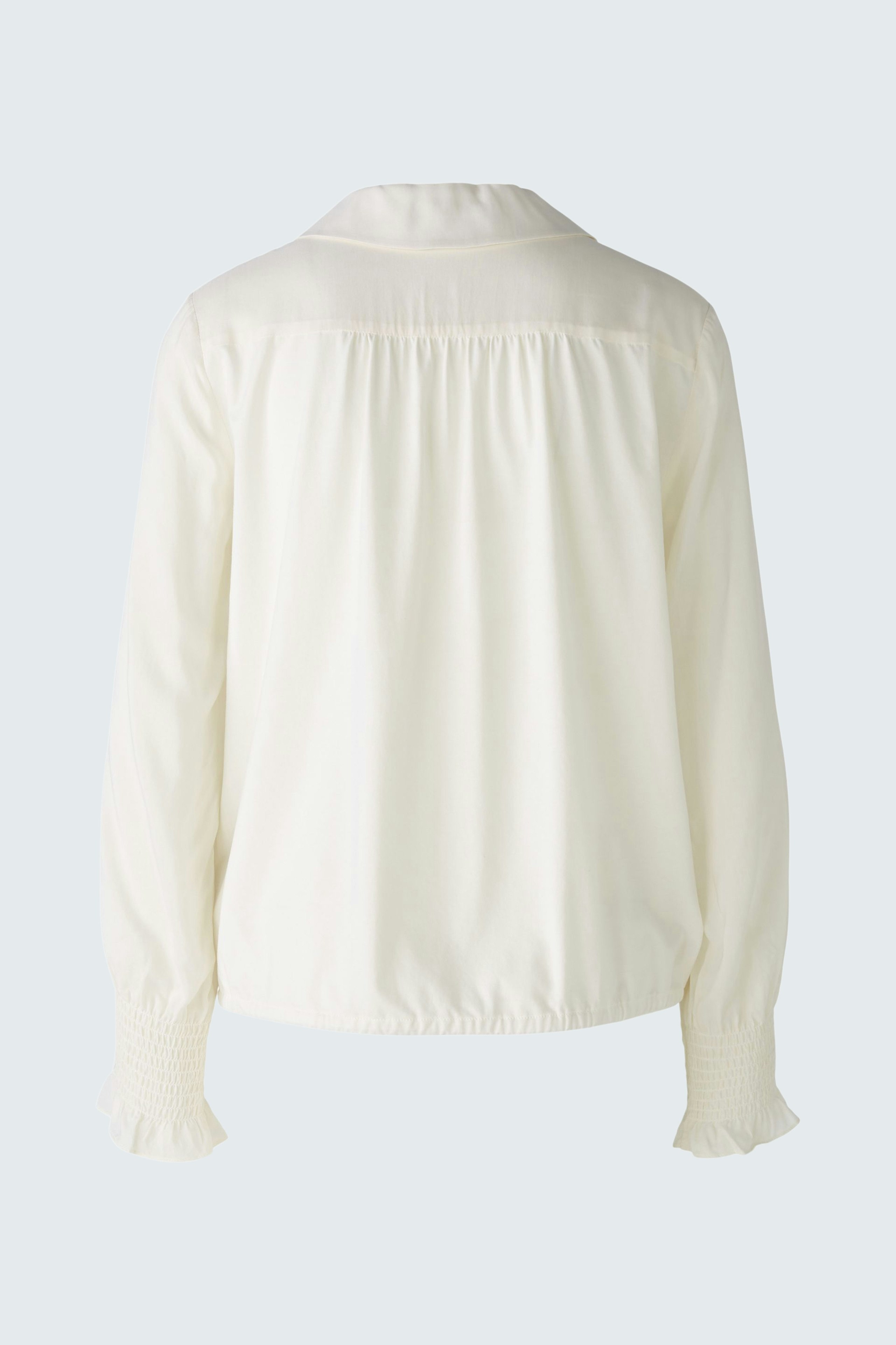 Elegant women's blouse in soft white fabric with a relaxed fit and subtle detailing.