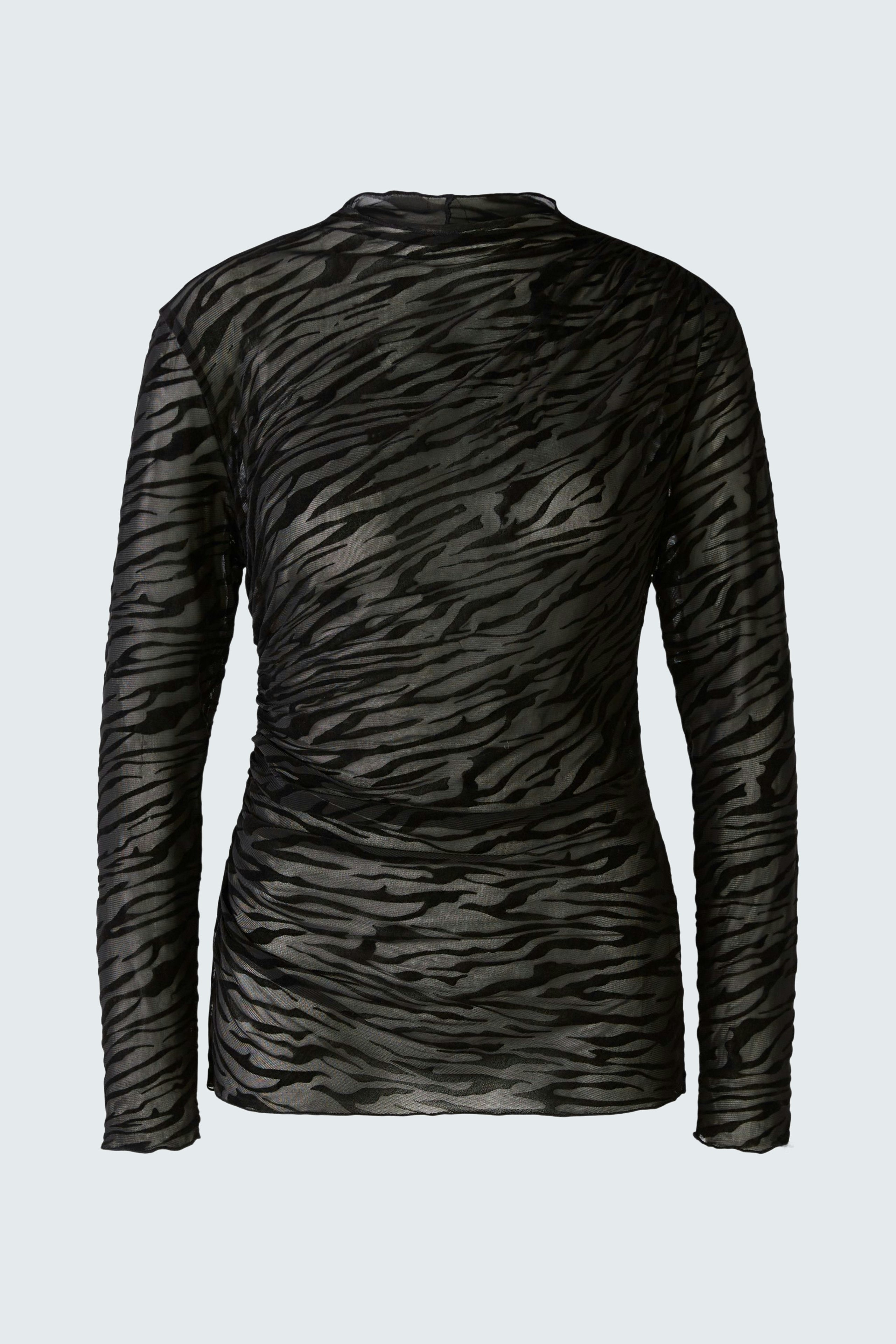 Stylish long-sleeve shirt: A woman in a black sheer pullover with a subtle tiger print.