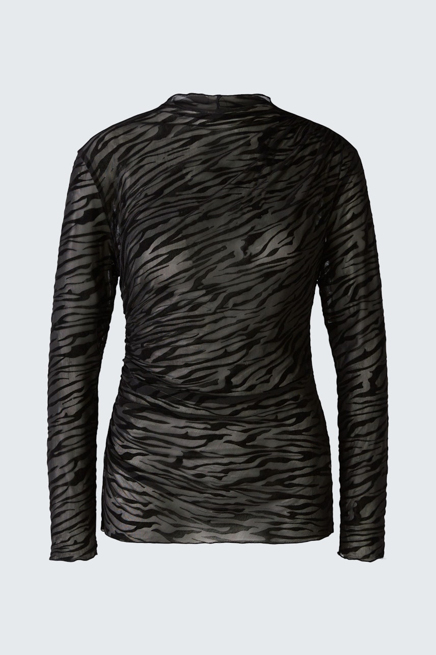 Stylish long-sleeve shirt: A woman in a black sheer pullover with a subtle tiger print.