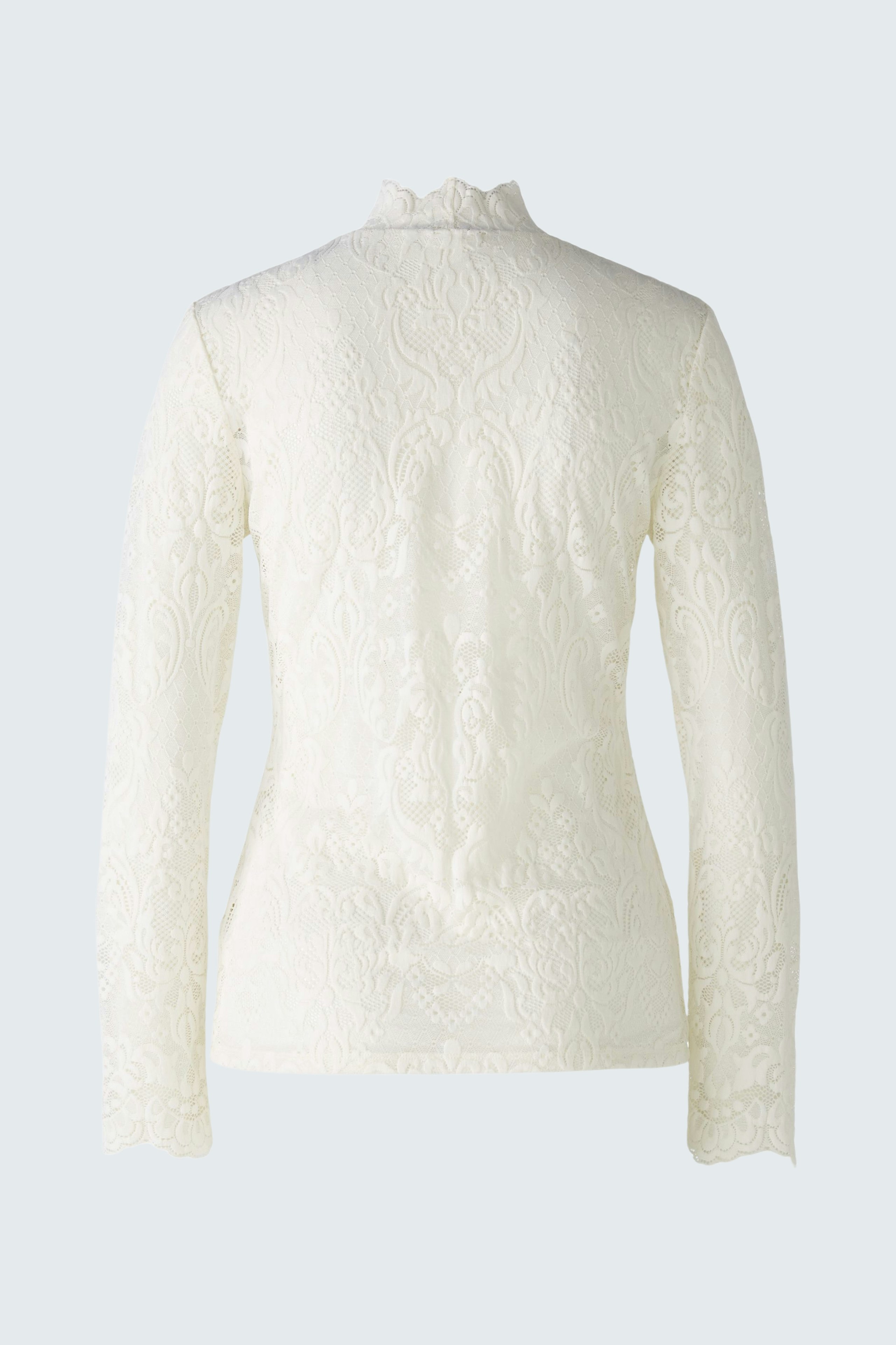 Elegant long-sleeve pullover: A woman in a textured white pullover with a high collar.